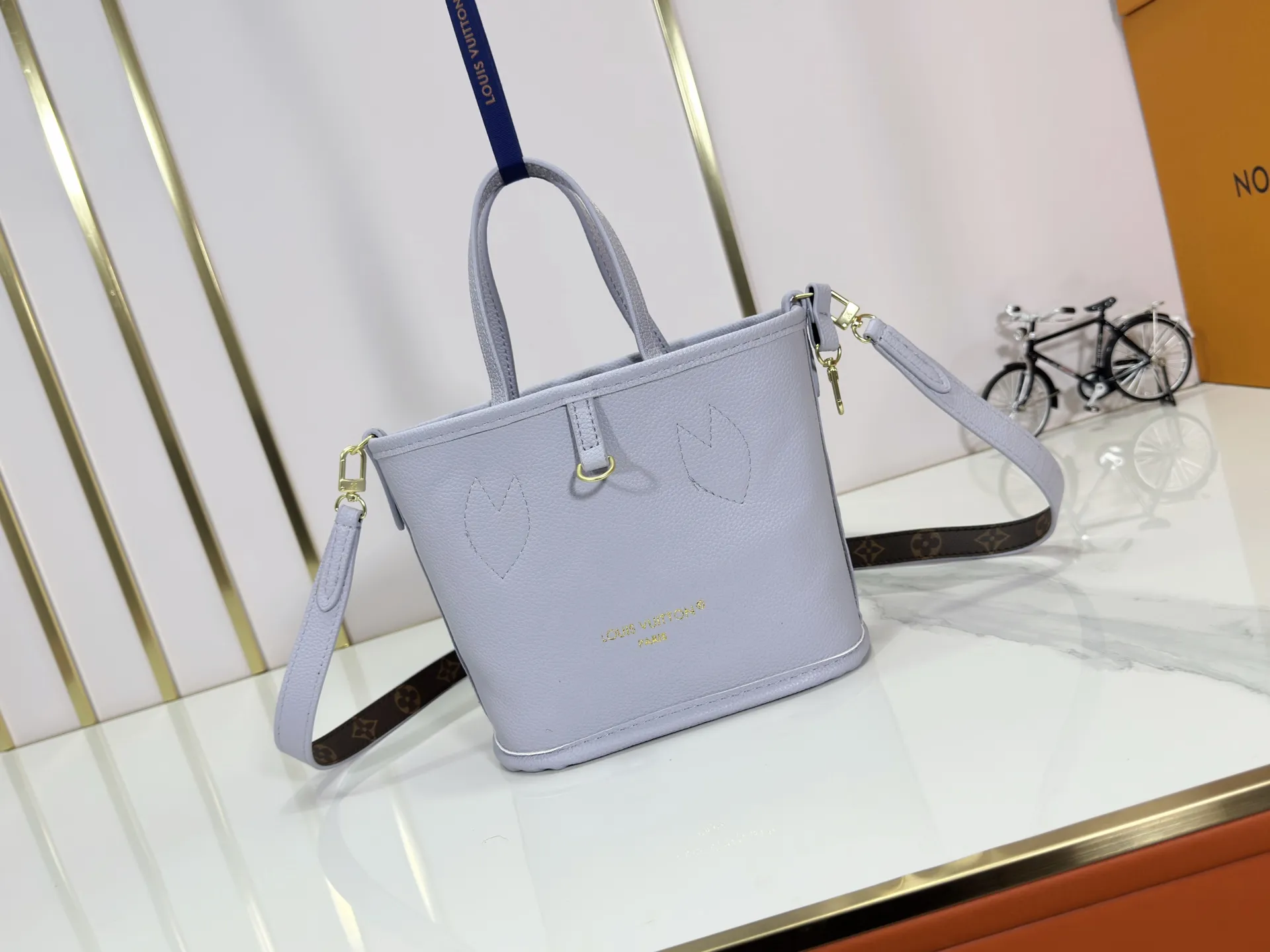 P240 M25656 M12099 Upgraded original Neverfull Bandouliere Inside Out BB handbag is a double-sided version of the classic design this season, with the front and back decorated with iconic Monogram canvas and grained leather. The removable zipper bag can be used alone or hung externally. The detachable shoulder strap makes it easy to wear cross-body, and the dazzling metal hardware adds a sophisticated detail. Dimensions: 26.5 × 16.5 × 11 cm