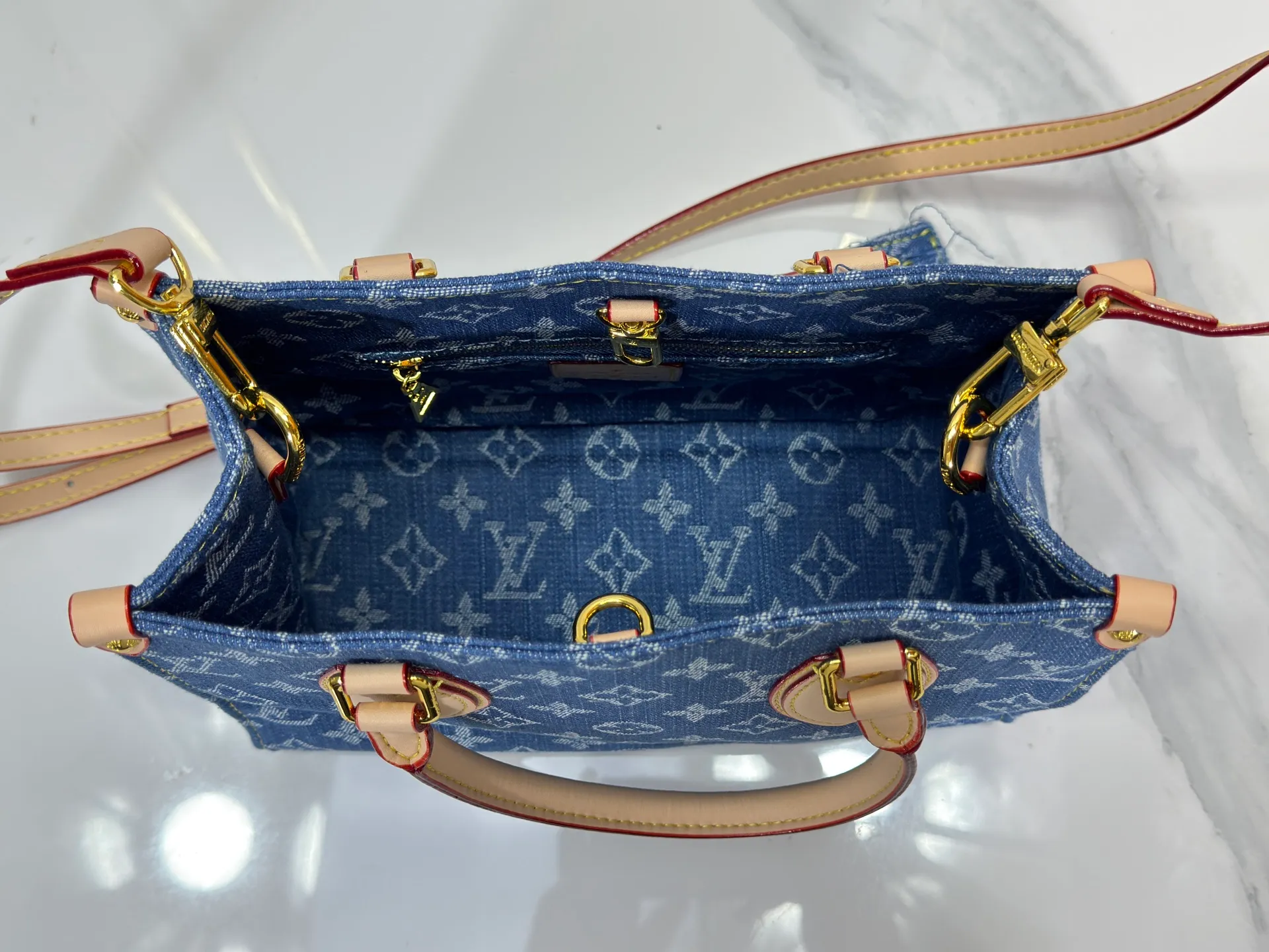 P260 Upgraded original M14633 M46373 Blue denim denim square bag This small OnTheGo handbag is made of cotton denim woven with Monogram pattern. It is bleached and sand washed to present a retro style. Detachable and Adjustable Shoulder Strap for a Subtle Fit The detachable shoulder strap makes it easy to carry small items like an iPad Mini with you. Detailed features 25x 19 x 11.5 cm.