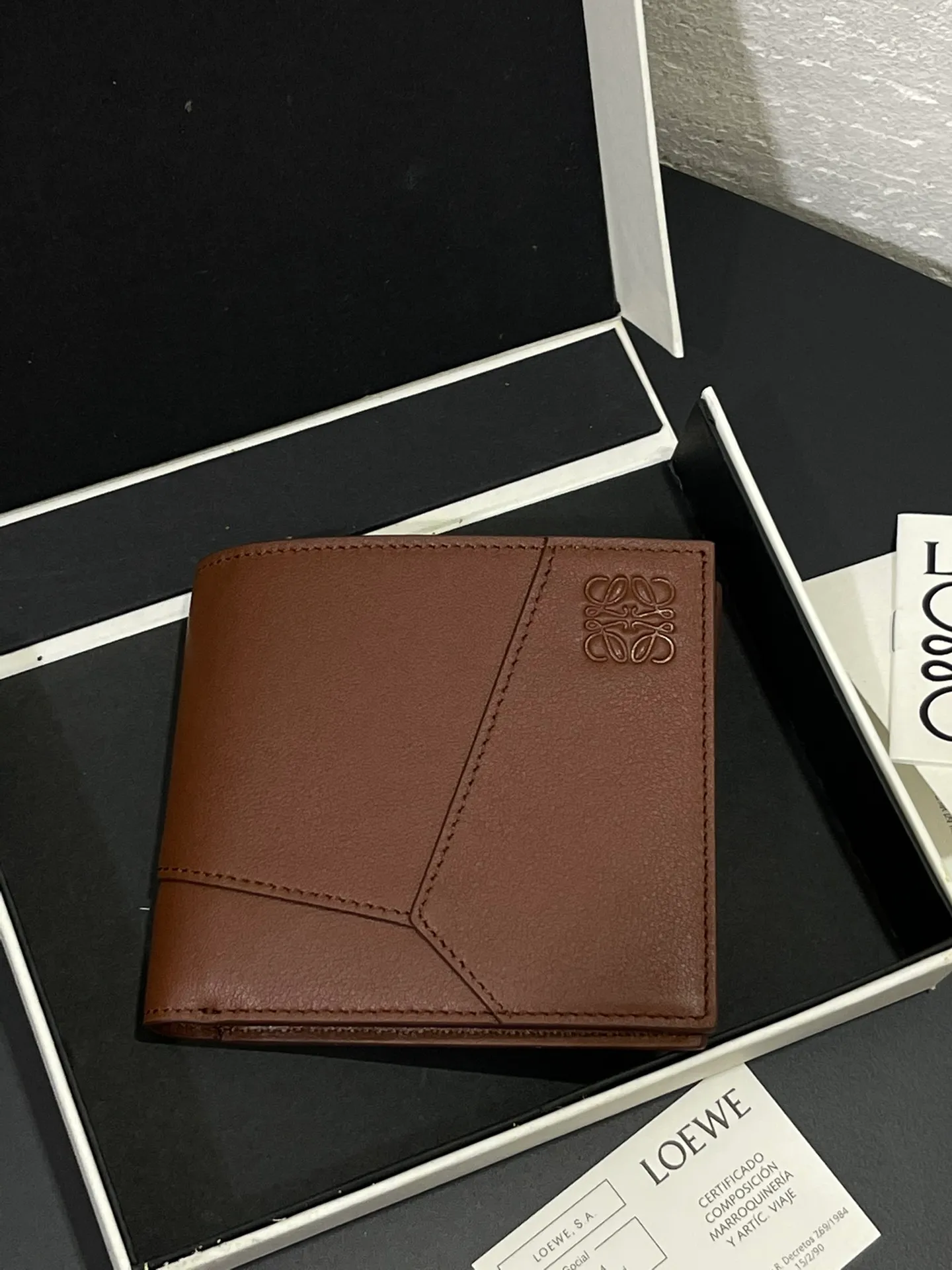 Men's bifold wallet is shipped. The wallet is inspired by the puzzle series handbags. It adopts a unique geometric pattern. It is made of classic calfskin. It has eight card slots and two large pockets. Style number 3801. Size 11*10 💰330