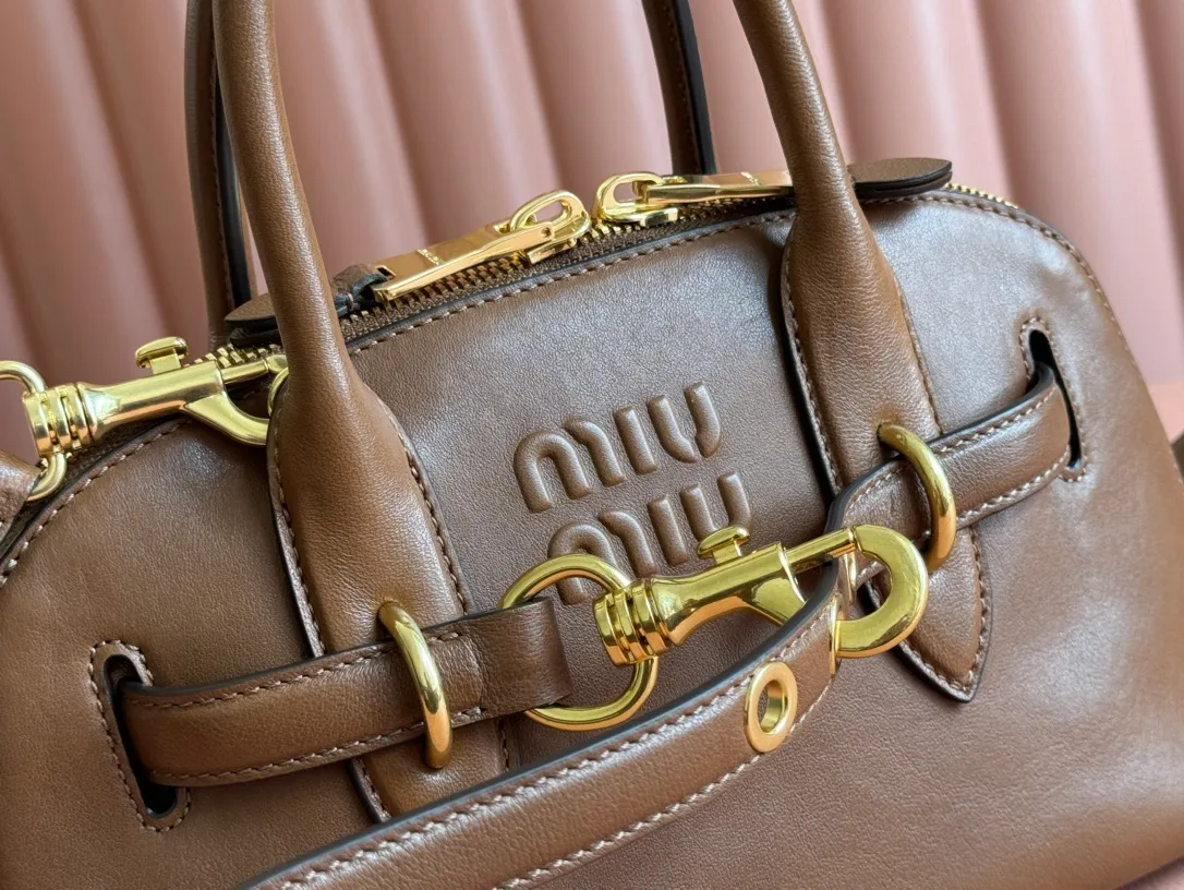 p1900💋💋💋【Original leather configuration counter packaging】Miu's new popular bowling bag, using top-grade retro vegetable soft sheepskin, retro frosted old metal accessories, this Aventure Nappa leather handbag is inspired by A Miu collection item, its structure has been adjusted to become lighter and rejuvenate with a new personality, creating a classic bag with timeless charm. The multi-element design gives this handbag a unique beauty and classic atmosphere. It has a detachable and adjustable leather shoulder strap. The canvas lining is equipped with zipper pockets and patch pockets. Dimensions: 28 X16.5 X 10 cm. Model 5bb169