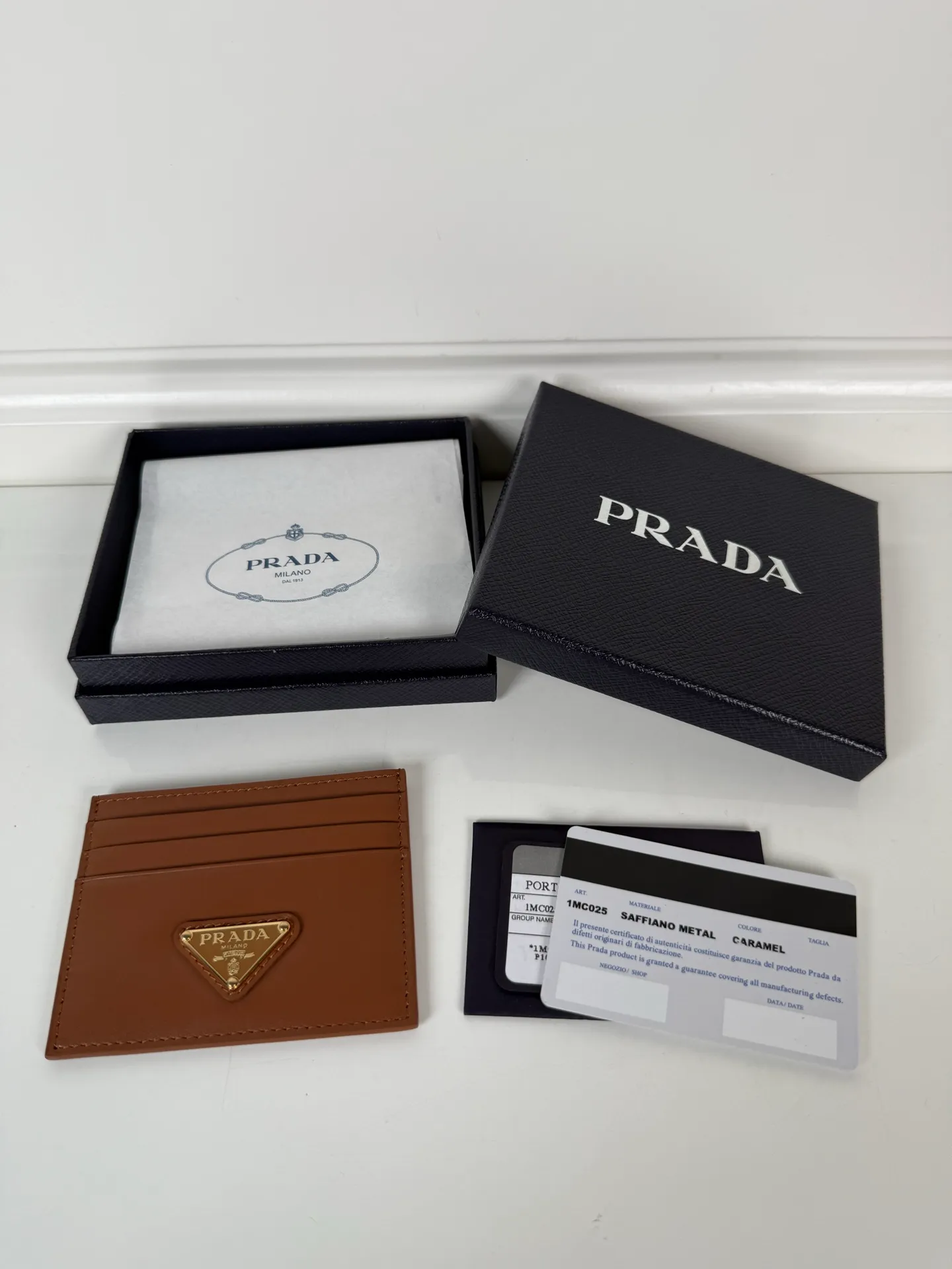 💰300, P Home➡️ Plain nappa leather small card holder, caramel color, unisex style, model 1MC025, original quality, 6 card slots ➕One middle compartment, can hold multiple cards and zeros 💰, size 11.2×8.5cm, real shot, what you see is what you get