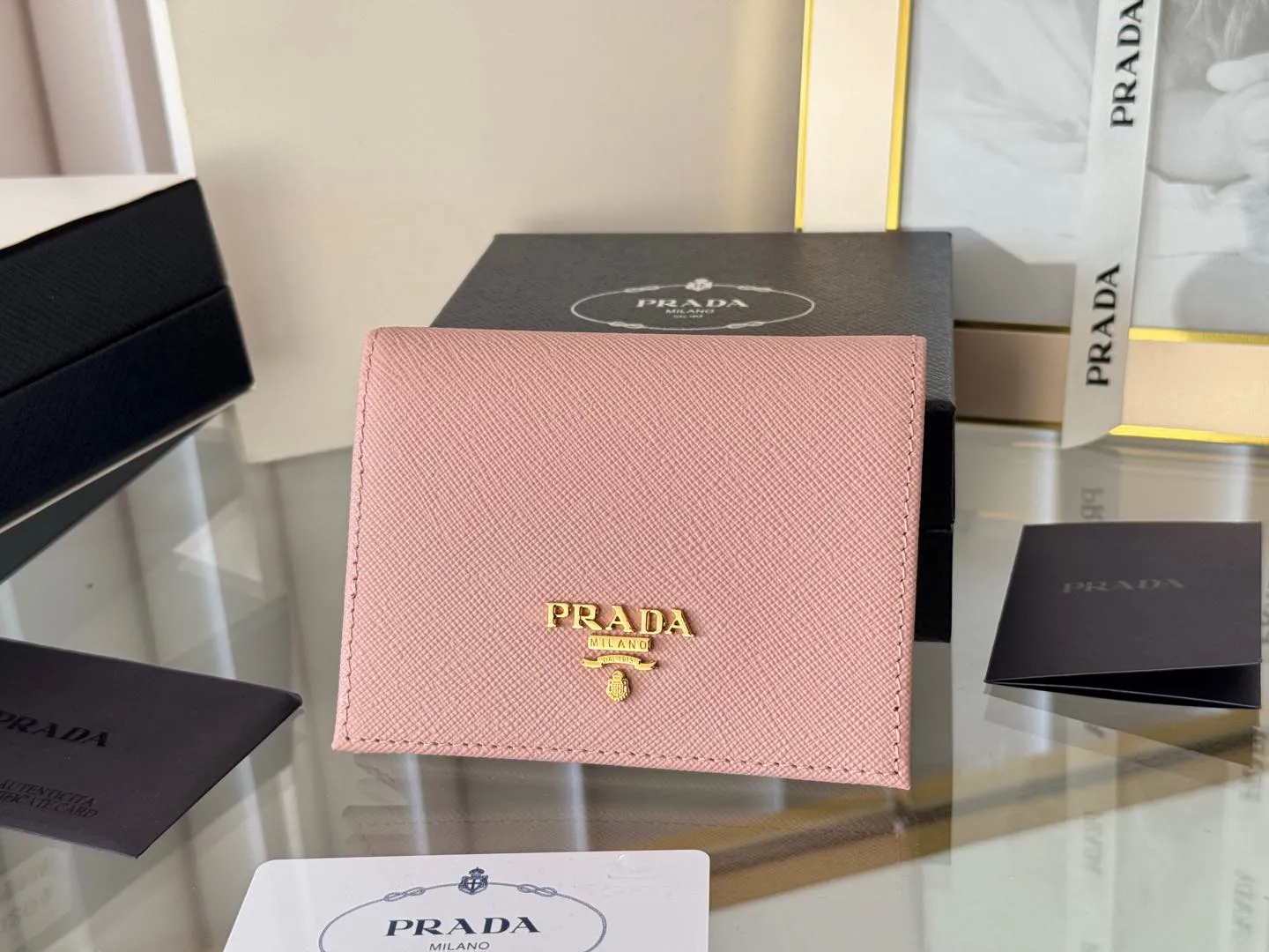 Prada women's two-fold short clip, with coin pocket and coin pocket. Model 1M0204, cross-grain cowhide. Size: 11.2x9.5cm. Simple and practical to enhance personal taste.