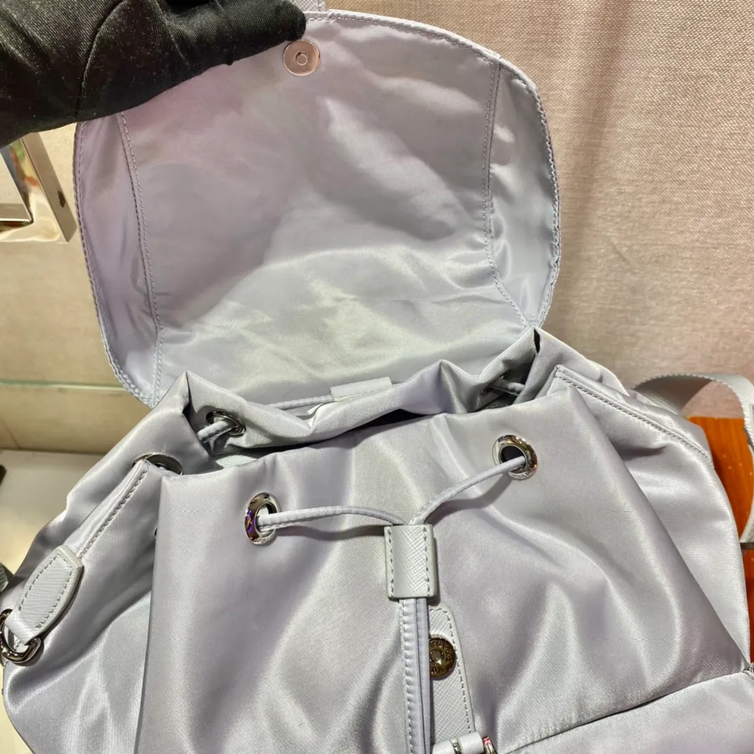 💰1120🎉New Backpack🎉1BZ811👍👍New Color🎉🎉This nylon backpack is trimmed with exquisite Saffiano leather, a blend of multiple materials, and decorated with a triangular logo, highlighting fashionable elegance. It also comes with a detachable small handbag😘😘Light and practical, the upper body effect is super stylish, and it can be matched at will😘😘Fully upgraded nylon fabric👍👍Length 30x Height 32x Bottom 15cm👏👏👏💰💰💰