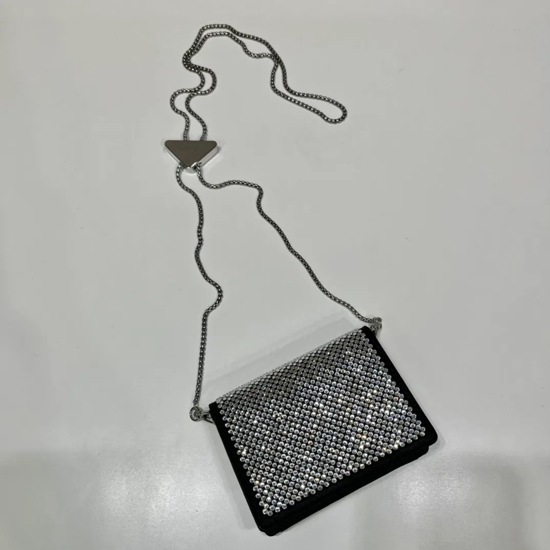 💰760🎉Necklace Crystal Pouch🎉1MR024🎉🎉 This Duchesse fabric card holder is decorated with imitation crystals throughout, creating a light and shadow style and iridescent colors on the surface, highlighting a gorgeous yet functional design. My favorite is this detachable and adjustable iron shoulder strap, which can be used as a waist bag decoration😍😍 or as a necklace decoration with clothes. The triangle mark in the middle can be adjusted, giving the item a variety of ways to wear it. The space can be used to hold lipstick 💄/earphones/keys🚗....it bling bling under the night light, so beautiful. Worth buying 🎉🎉 Length 11.5x Height 8cm