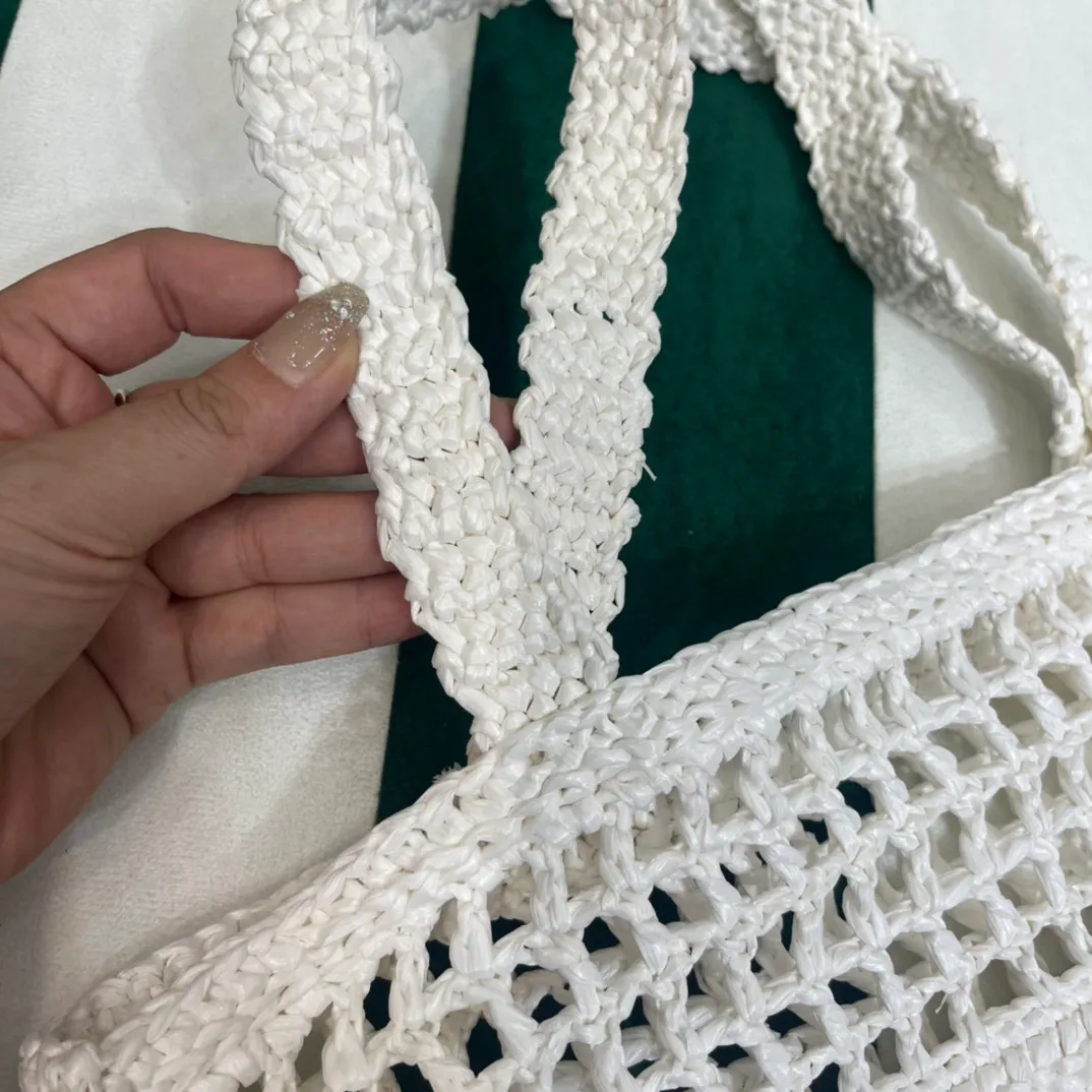 💰1160 Raffia Upgraded Version/White🦴 𝗣𝗿'𝗮𝗱𝗮Raffia Fiber Tote Bag Made of high-quality imported raffia🌿 Purely handmade! Every craftsman makes it with care and crochets it stitch by stitch! How can summer outings, picnics, and photo shoots be complete without a beautiful, lightweight and chic straw bag? 393 Size: 36×4×38cm