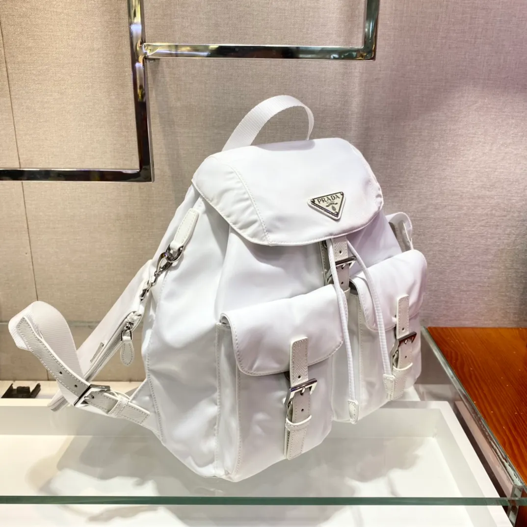 💰1120🎉New Backpack🎉1BZ811👍👍New Color🎉🎉This nylon backpack is trimmed with exquisite Saffiano leather, a blend of multiple materials, and decorated with a triangular logo, highlighting fashionable elegance. It also comes with a detachable small handbag😘😘Light and practical, the upper body effect is super stylish, and it can be matched at will😘😘Fully upgraded nylon fabric👍👍Length 30x Height 32x Bottom 15cm👏👏👏💰💰💰