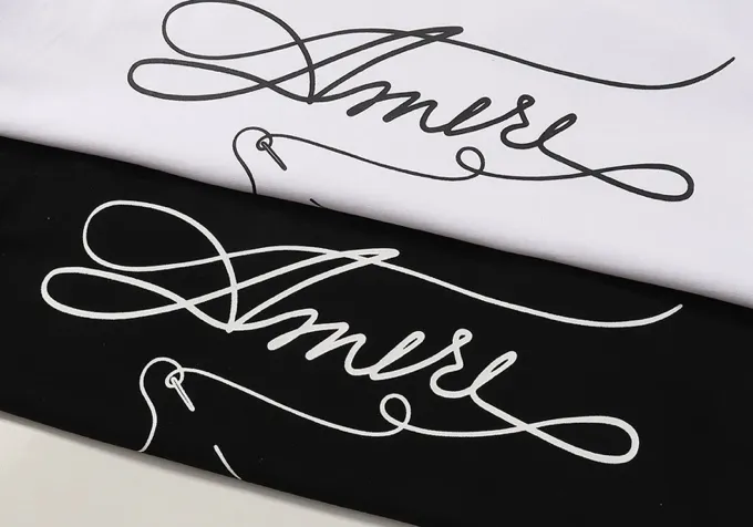 Style number: 701 P114 Fabric: 260g double yarn AMIRI 2025 spring and summer new logo round neck T-shirt high street same style for men and women loose classic letter short sleeves Color: White Black Size: S M L XL