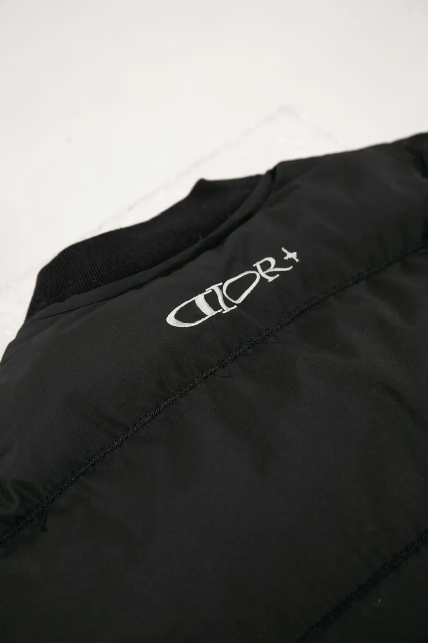 DIOR AND LEWIS HAMILTON JACKET Black technical fabric with removable sleeves This jacket is from the DIOR AND LEWIS HAMILTON limited series. Crafted from black technical fabric and embellished with DIOR AND LEWIS HAMILTON embroidery, the graphic design highlights the iconic Dior signature. With detachable sleeves, it can be worn in two different ways. It can be paired with jeans to create a low-key sporty look. DIOR AND LEWIS HAMILTON Embroidery and zip Knitted collar Detachable sleeves Front and internal flapless pockets Body: 100% nylon, Lining: 100% nylon