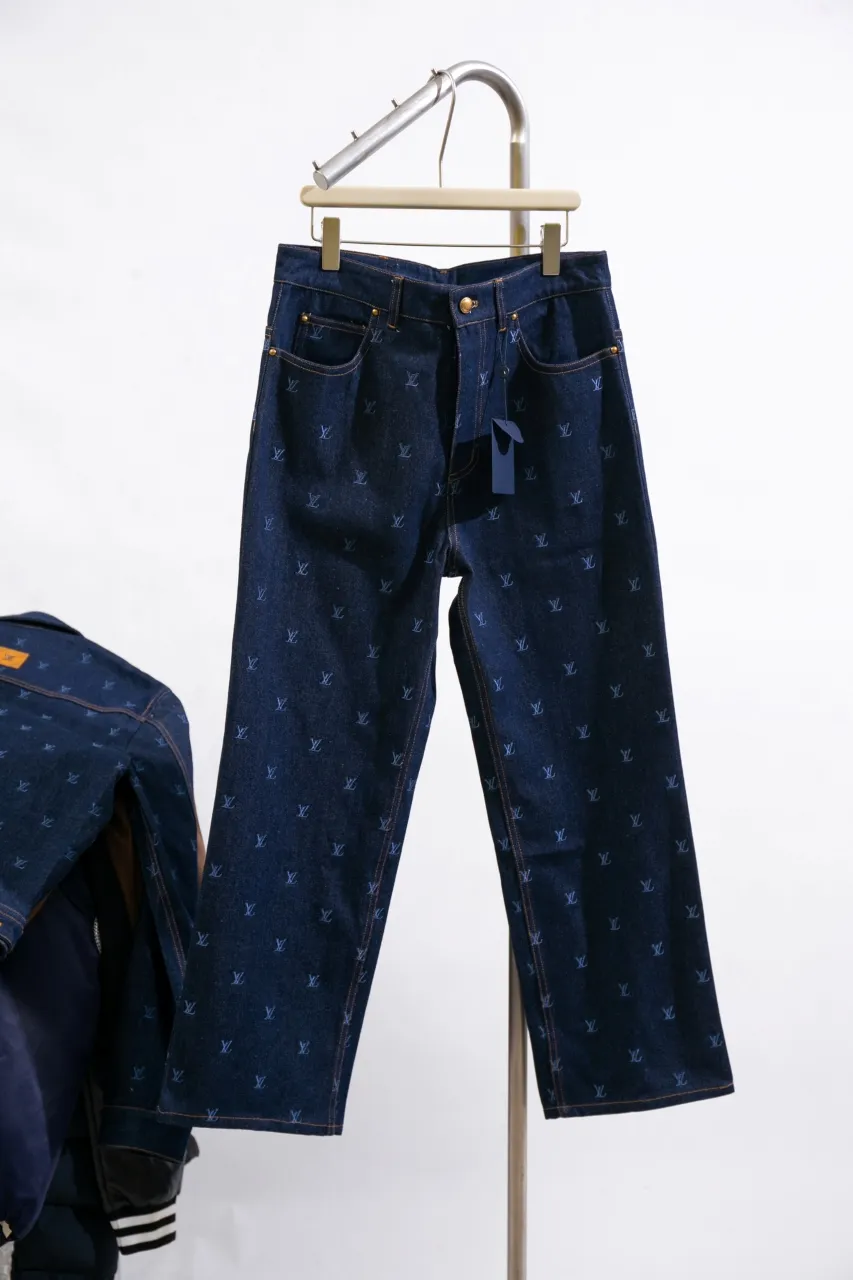 LV Embroidered Jeans This pair of jeans is made of original washed denim, with an all-over LV Blason pattern embroidered with fine yarn. The classic silhouette is finished with a Damier nubuck label and LV metallic accents, making it a sophisticated addition to the matching jacket.  Standard fit All-over LV Blason embroidered Damier nubuck label with LV metallic accents