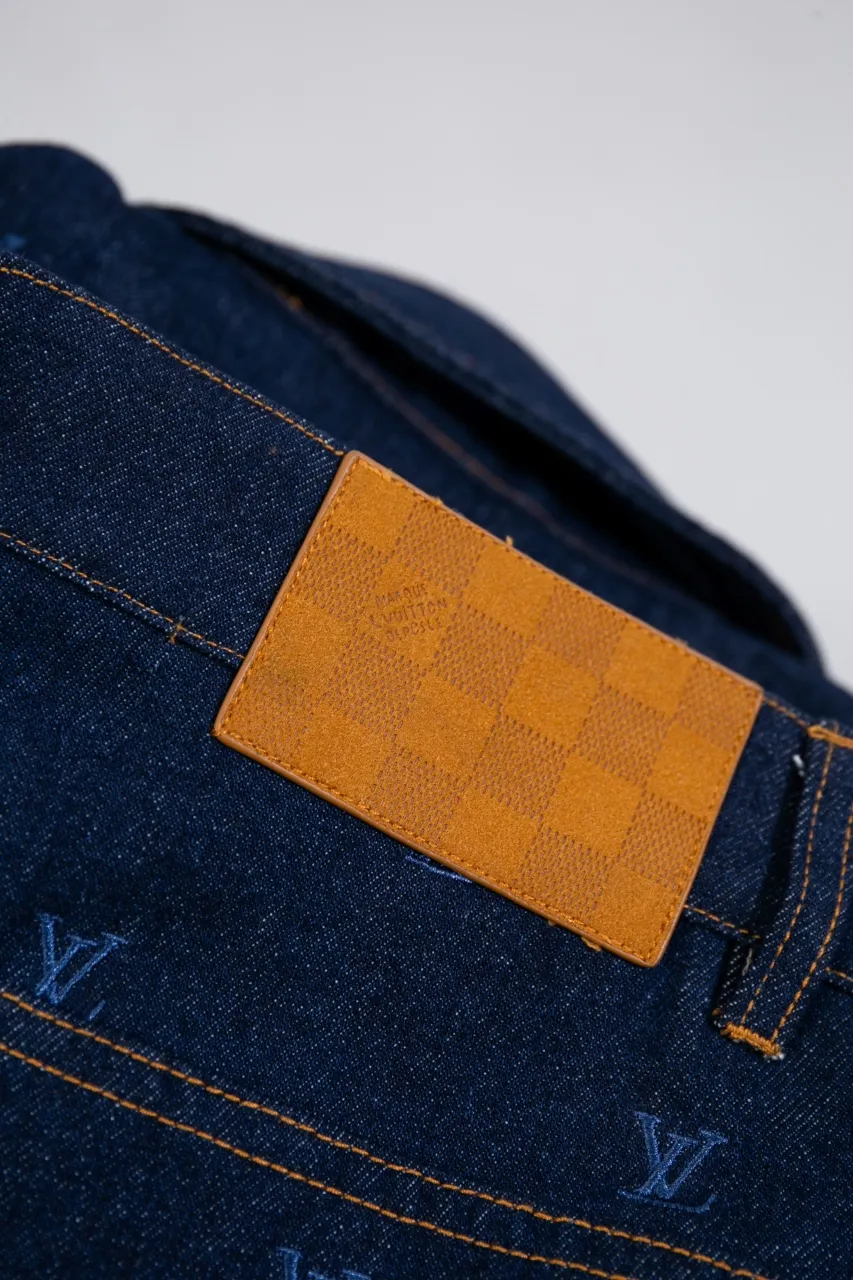 LV Embroidered Jeans This pair of jeans is made of original washed denim, with an all-over LV Blason pattern embroidered with fine yarn. The classic silhouette is finished with a Damier nubuck label and LV metallic accents, making it a sophisticated addition to the matching jacket.  Standard fit All-over LV Blason embroidered Damier nubuck label with LV metallic accents