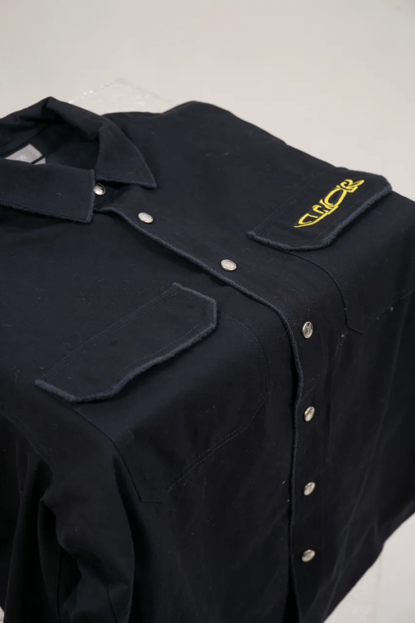 DIOR AND LEWIS HAMILTON Navy blue cotton denim overshirt This overshirt is from the DIOR AND LEWIS HAMILTON limited collection. Crafted from navy blue cotton denim, it features contrasting DIOR AND LEWIS HAMILTON embroidery on the chest and back, a graphic design highlighting Dior's iconic signature. Wear it with the matching jeans for a comfortable, oversized fit. Contrasting DIOR AND LEWIS HAMILTON embroidery on chest and back Button closure and cuffs Chest flap pocket 100% cotton