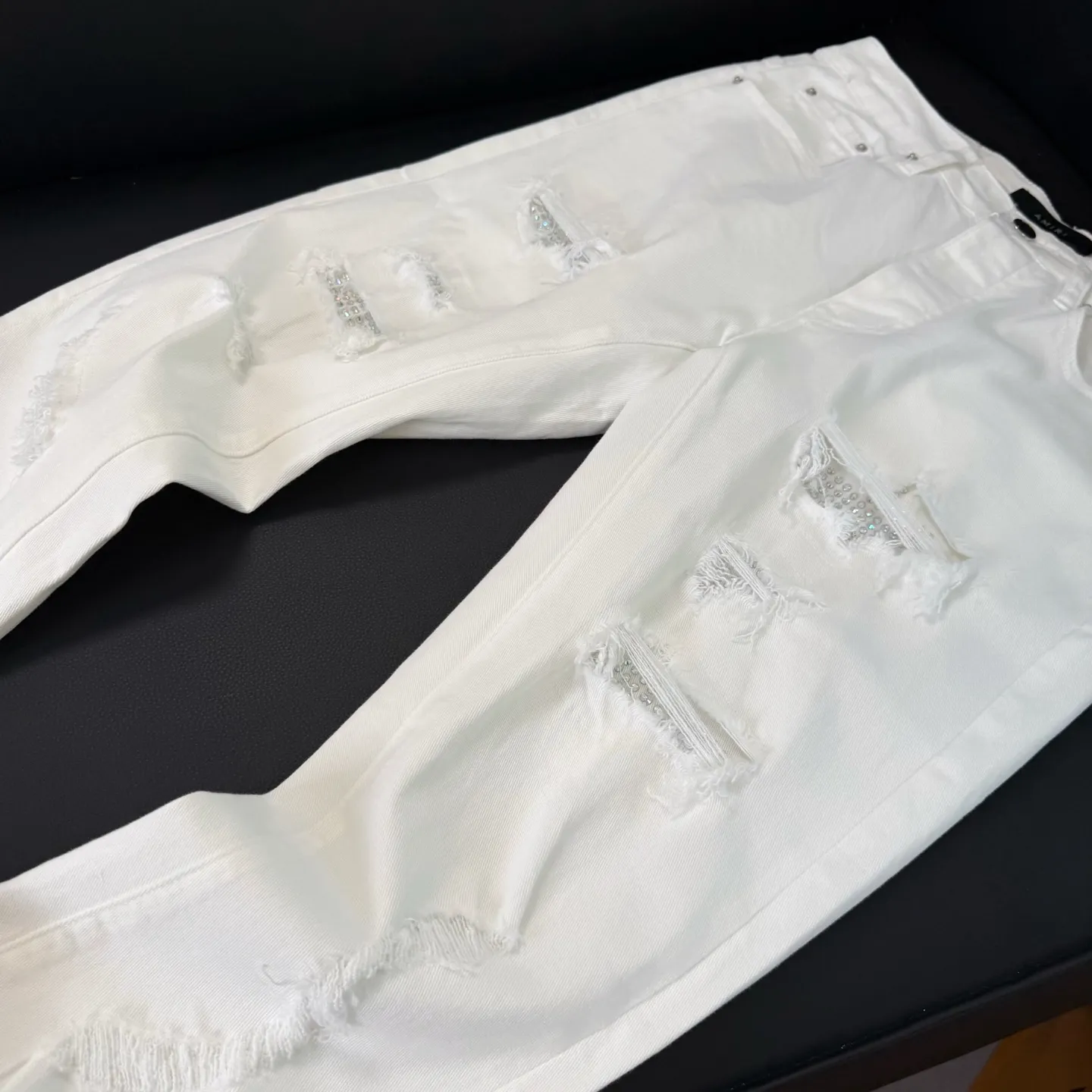 P260 💰Top model number: D289 Non-market Amiri white hot diamond patched ripped high street slim jeans • amiri is transliterated as Emil, which is the name of the founder. Mike Amiri, the founder of amiri, grew up in Los Angeles, USA. He was influenced by local street culture and Punk Rock since childhood, so he founded the amiri brand named after himself. A variety of trendy brand clothing meets the needs of different fashion players. Amiri clothing has novel and unique styles and is a well-known street brand in the United States. The styles and styles of many clothes are loved by many street photographers. The various clothing styles meet the dressing needs of different people, show their unique temperament, and show the trend of dressing. amiri's jeans are relatively famous. Not only do they have many styles, but the quality of the jeans is also very good. Many celebrities have also worn amiri brand jeans.  The jeans of the amiri brand break through the production process and cutting of the original jeans. The fabrics are relatively soft and comfortable, and are not as hard as some jeans, which can irritate the skin and cause the skin to bleed when worn. Los Angeles trendy brand Amiri's jeans are made with great detail from tailoring to texture, adding wrinkles, bullet holes, damage and other details to add to the trendiness of the jeans. You can choose the style that suits you according to your own needs. Only when you wear a suitable style can you have a certain sense of fashion.  In recent years, high street has become a word that appears more and more frequently in men's clothing. High street style has also become an important direction for everyone's matching. High street-related items basically cannot avoid oversize or drop-shoulder tops. The lower body is matched with trackpants or tight-fitting denim. In my opinion, the most representative one may be denim. What I bring to you today is the MX1 hot-drilled patch denim worn by many Internet celebrities. It is made by a large washing factory in Guangzhou. The front and back have frayed trouser legs and holes. Full of high-end sense. Knee part damage design with leather patchwork design. Already used as facade design. Leather waist nameplate. Customized crotch placket hardware. Engraving mold opening. The focus of this style is not on washing, but on the shape and version of the damage. The secret lies in the craftsmanship of the master. Later, the cost of fraying, horse cutting, knife cutting, etc. These hand-made products are far beyond comparison with assembly line products.  Color: Picture color Size: 30-31-32-33-34-36