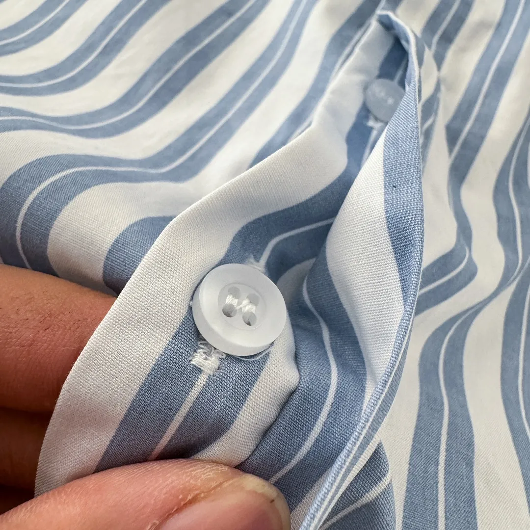 Ami Paris Oxford cotton button-down corner collar casual shirt-blue heart thick striped long-sleeved shirt-same style for men and women. Blue small love letter embroidery decoration fashionable and versatile long-sleeved shirt! On sale simultaneously at counters!  A well-known French affordable luxury fashion brand. The brand's classic elements are embellishments sought after by major celebrities. Its basic simple design and fashionable style make it a must-have couple's shirt for men and women!  Made of custom-woven 100% Oxford cloth pure cotton, it feels soft and delicate, has excellent moisture absorption and perspiration performance, and is very comfortable and skin-friendly when worn next to the skin! The chest of the shirt is decorated with the classic love letter A logo embroidery. The top-notch embroidery technology is tight, full and full of details, and is cleverly embellished with bright red. It carries all the eye-catching points. It follows the consistent minimalist French attitude. The fabric is soft and comfortable, suitable for any versatile casual shirt couple!  Color: Blue Stripe Size: S-XL S: Bust 106 Shoulder Width 47 Clothing Length 71 Sleeve Length 60 M: Bust 110 Shoulder Width 48 Clothing Length 73 Sleeve Length 61 L: Bust 114 Shoulder Width 49 Clothing Length 75 Sleeve Length 62