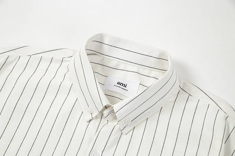AMI Paris classic autumn red love heart embroidered on the chest. Casual cotton large striped short-sleeved Oxford shirt. Original custom-made 180g pure cotton fabric. Loose off-shoulder version. Same style for men and women. Color: black and white, blue and white. Size: S-XL.