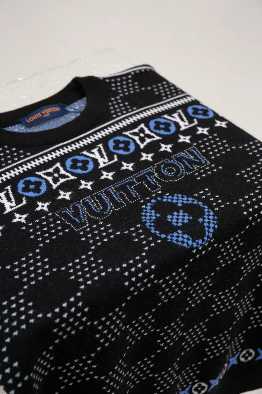 LV Jacquard Sheep Wool Pullover Sweater This pullover is made from responsibly sourced sheep wool. It outlines the classic pattern and the brand's logo jacquard texture on a deep background, and then reinvents the Fair Isle sweater with a soft dropped shoulder design. Wear it over a ski jacket or light up the campfire.  Standard fit All-over LV Fair Isle jacquard with Damier and Monogram details Vuitton logo jacquard in the center
