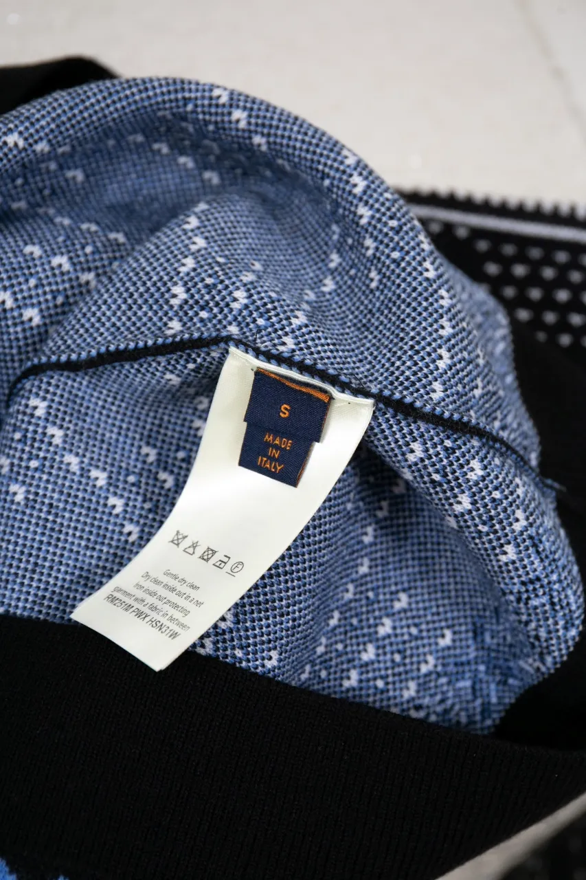 LV Jacquard Sheep Wool Pullover Sweater This pullover is made from responsibly sourced sheep wool. It outlines the classic pattern and the brand's logo jacquard texture on a deep background, and then reinvents the Fair Isle sweater with a soft dropped shoulder design. Wear it over a ski jacket or light up the campfire.  Standard fit All-over LV Fair Isle jacquard with Damier and Monogram details Vuitton logo jacquard in the center