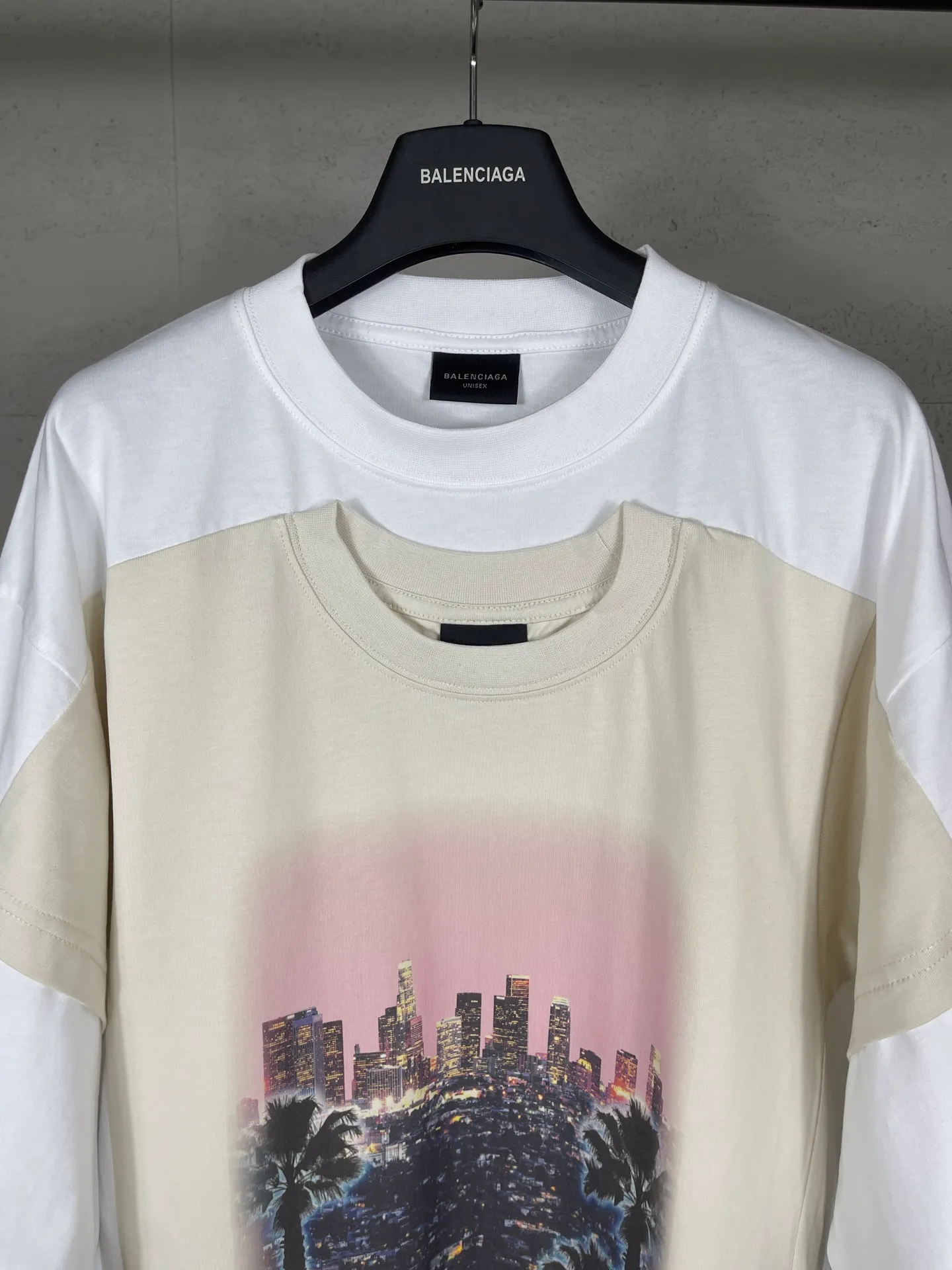 🅿️226 Actual pictures [Top version. Official website quality] BALENCI*GA/25 new model. The front is directly printed with the Los Angeles night scene, overlapping double-layer short-sleeved T-shirt #overlapping dark line stitching, the latest SS25 style with super heavy craftsmanship. Research and development at the first time, different market currencies. Comparisons welcome. The fabric is made of Paris ZP custom-woven and dyed cotton double yarn. Weighing 260 grams, the cloth surface is clean. The cloth pattern is clear, soft and comfortable. The threads are dyed with no color difference. Printing adopts computer direct printing. Jubie market currency. Welcome to compare. The version adopts OS loose shoulder design. Same style for men and women. Code: BL253710 Color: White Size: XS S M L