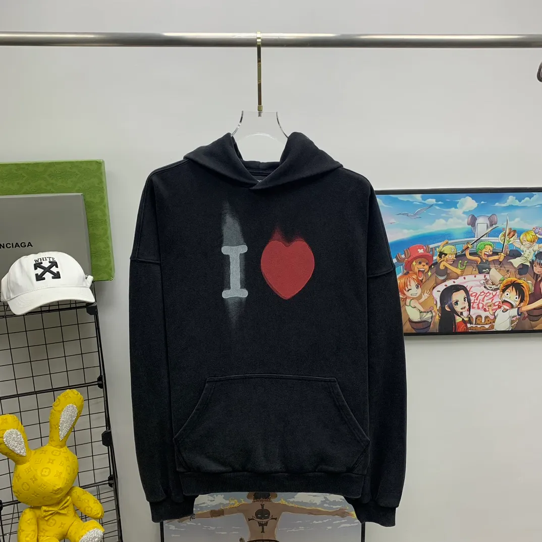 The top tried and tested version of BALENCIAGA's love ❤️printed male and female couple star's same style pullover hoodie sweatshirt. Decorated with I ❤️art work embroidery on the front｜brand logo embroidery on the lower back｜distressed effect. Heavy 480g pure cotton terry fabric, full of feel. The weight of the ready-made clothes is more than one kilogram, and the drape is very good! The new plate-making process that imitates hand embroidery has the rough feel of hand embroidery, and the stitching method is adjusted according to the original pattern. After embroidery, the stitching technique is imitated by hand embroidery, and the smooth curves highlight the embroidery effect.  The main body of the logo pattern is precision stitched; the embroidery is very fine and dense. Linen embroidery thread is used combined with dense processing to increase the three-dimensional effect, and the embroidery body has a subtle matte visual texture. Color: washed black white Size: S--XL P:390