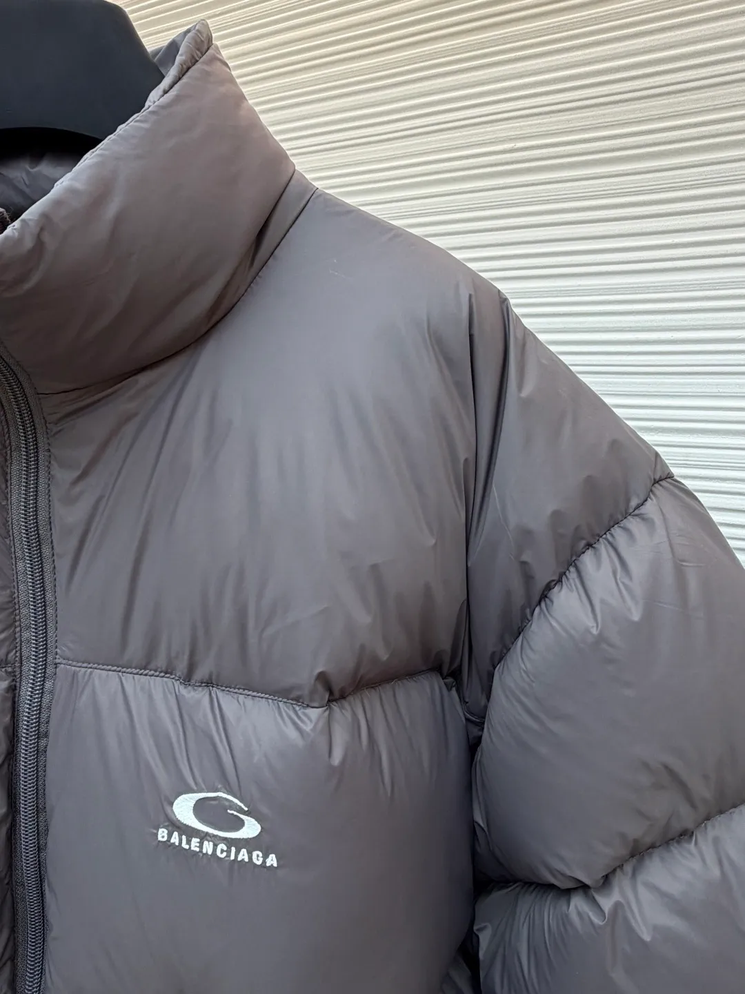Balenciaga single-loop embroidery down jacket ●Original version: Purchased and developed by 12336 ●Item number: 1681876-D15 ●Fabric: white duck down fabric ●Technology: mechanical down filling ●Color: gray ●Version: loose version ●Weight: about 750 grams ●Size: S-M-L-XL ●Description: Custom-developed high-count and high-density woven fabric is the cornerstone of its high-end texture. High count means that the yarns are extremely fine, resulting in a finely textured and silky-touch surface; high density gives the fabric excellent stiffness, abrasion resistance and wind resistance. It avoids the rough feeling of ordinary cotton canvas and presents a low-key and precise micro-gloss, which provides a perfect and stable foundation for subsequent embroidery and hemming processes. The filling process needs to ensure that the cotton body is evenly distributed within the quilting grid without holes or agglomerations, which requires extremely high filling accuracy. The hemming is like the steel frame of a building, which strengthens the overall silhouette of the vest and makes the lines sharper and clearer, reflecting the brand's meticulous attitude towards tailoring. Dense embroidery on this thin and dense fabric can easily cause the fabric to shrink and deform. The brand will use special water-soluble lining or hot-melt lining on the bottom layer of embroidery. These linings will disappear after the embroidery is completed, ensuring that the pattern is smooth and crisp without destroying the flexibility of the fabric itself. This is the ultimate test of the combination of handicrafts and technology. The overall wiring is straight and delicate, the fabric is comfortable and soft, and the color is consistent without color difference. It can be matched with the same style to create a fashionable look and control various occasions. Customized accessories, complete with three standards, same style for men and women!