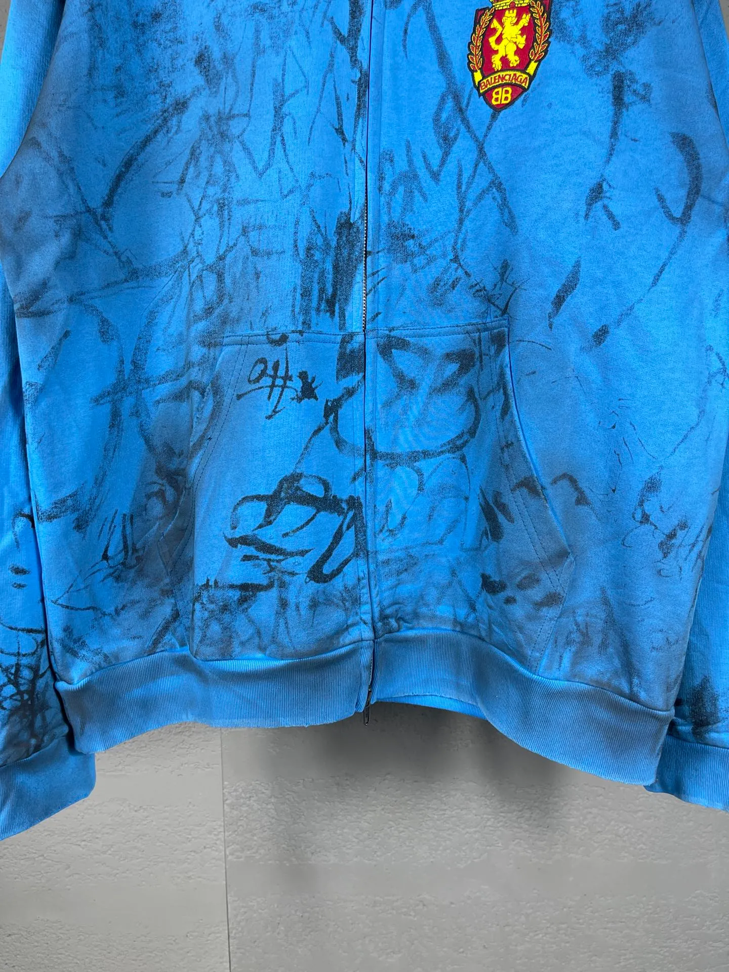 🅿️456 real photos [Top version. Official website quality] BALENCI*GA/Paris co-branded Manchester United. 24 latest. Hand-painted. Worn. Washed. Distressed. Worn. Inkjet painting. Graffiti. Zipper cardigan hooded sweatshirt. The embroidered insignia is heavily tattered. Top-quality board. Comparisons are welcome. The fabric is made of Paris ZP custom-woven and dyed cotton double yarn. Weighing 260 grams, the cloth surface is clean. The cloth pattern is clear, soft and comfortable. The threads are dyed with no color difference. The front pattern embroidery is made with imported machine embroidery. The color of the chapter mark is the same. The embroidery and border are embroidered. The chapter mark is worn and distressed to match the brick cabinet. Ready-made clothes are washed and distressed. Painted with graffiti. The entire piece of clothing is restored with overweight craftsmanship. Jubie market produces pictures based on pictures. Welcome to compare. The version adopts OS loose shoulder design. Same style for men and women. Code: BL238079 Color: gray, red, lake blue Size: XS S M L