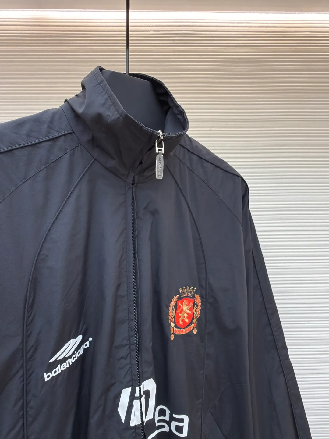 Balenciaga Manchester United co-branded No. 10 football jacket ●Authentic product: purchased and developed by 17699 ●Item number: 1680808-C65 ●Fabric: nylon fabric ●Technology: Printing ●Version: loose fit ●Size: 44-46-48-50 ●Description: Made of high-count and high-density nylon-cotton blended fabric. The lining is made of 32s combed cotton plain weave. The weight is 160g. It is embroidered by Tajima embroidery machine imported from Japan. The front panel + left and right sleeves are made of nylon material matte embroidery thread. The front and rear panels are made of DTF white ink heat transfer film material. The Y-plate pattern is scanned to make the pattern, and the material is cut by laser burning. The cut pieces are manually swept and positioned, and the front and back are hot-pressed with a high-temperature press machine to form. The letter composition on the front restores the flower effect, and the front and center are equipped with upper and lower rubber-threaded open-end zippers. Same style for men and women!