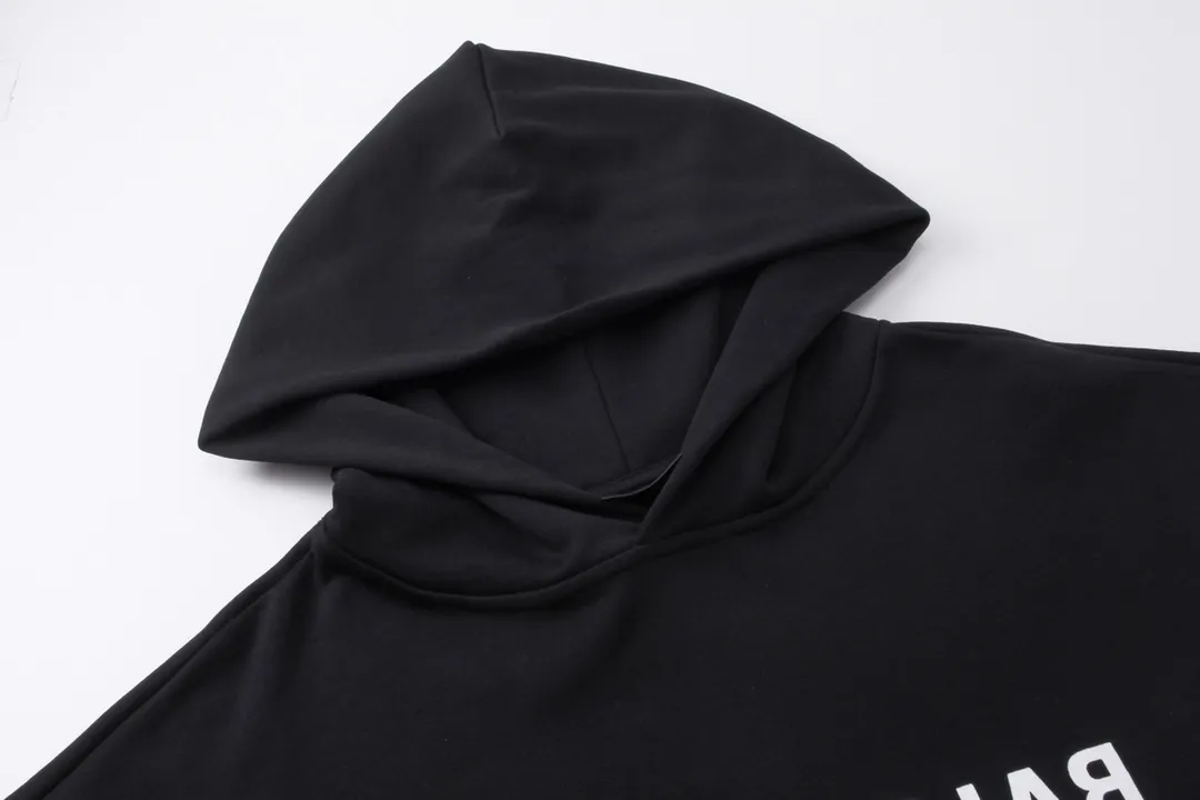 🅿️290 real photos [Top version. Official website quality] BALENCI*GA/Paris BALENCI*GA#2023 new autumn and winter style, front-printed reverse mirror LOGO hooded sweatshirt. Brick cabinet synchronization. The fabric is made of Paris ZP custom-woven and dyed cotton sweatshirt. The weight is 450 grams. The cloth surface is clean. The cloth pattern is clear. Soft and comfortable. Good color fastness. Not easy to change color. The threads are woven and dyed with no color difference. The printing uses imported environmentally friendly rubber paddles, precision stencils, fine LOGO letters, clear letters, no burrs, and a three-dimensional effect. Restore brick cabinet. The version adopts OS loose shoulder version. Same style for men and women. Code: BL238069 Color: black. Size: XS S M L