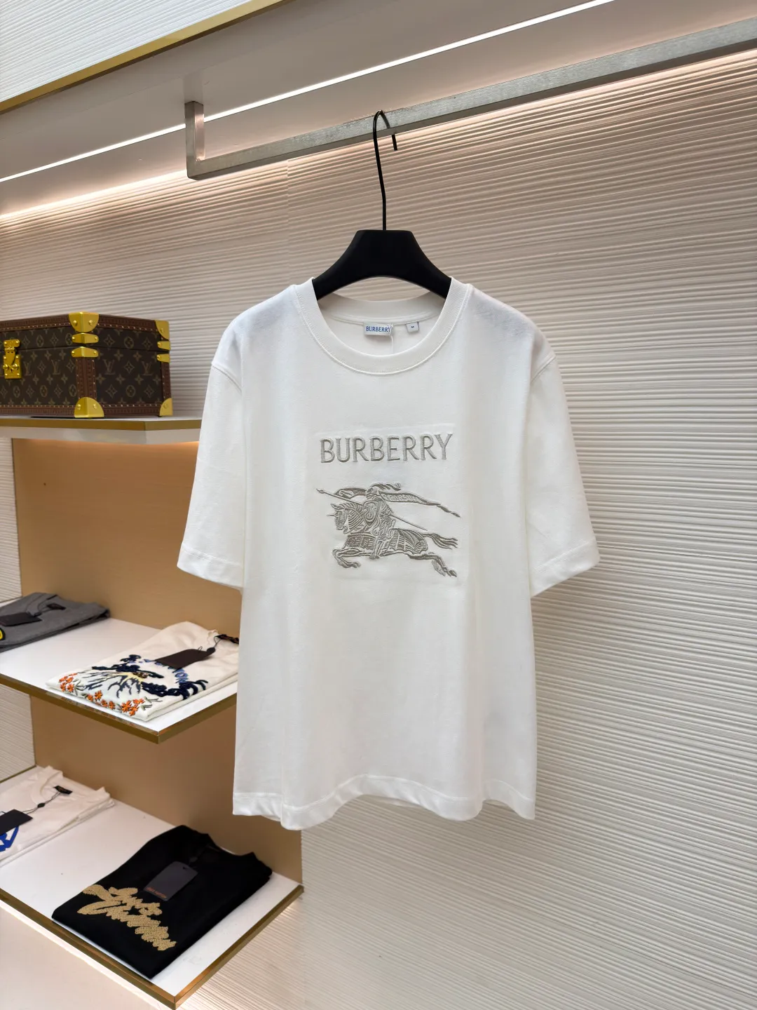Burberry Thin Line War Horse Embroidery Round Neck Short Sleeve ●Original version: Purchased and developed for 3250 ●Item number: 1681453-X85 ●Fabric: pure cotton fabric ●Technology: embroidery production ●Color: black ●Version: fitted version ●Weight: about 275 grams ●Size: S-M-L-XL ●Description: This T-shirt is made of high-quality pure cotton fabric, which is skin-friendly and breathable. The black and off-white tones are classic and versatile. The brand knight logo on the front adopts precision embroidery technology. The silk thread is rich in color, the stitching is delicate and three-dimensional, and the pattern is rich in layers, highlighting the high brand recognition. The round neck structure is processed by overlocking technology, and the neckline fits the neck and is not easily deformed. The body of the garment is sewn using industrial-grade flat stitching technology. The stitches are smooth and even, and the stitches at the hem and cuffs are fine and firm. From the selection of pure cotton fabrics to the control of embroidery details, every process reflects Burberry's pursuit of craft precision and classic style. It not only retains the daily practicality of the T-shirt, but also demonstrates the brand's light luxury recognition through exquisite embroidery. It is a fusion of casual style and exquisite craftsmanship. The overall wiring is straight and delicate, the fabric is comfortable and soft, and the color is consistent without color difference. It can be matched with the same style to create a fashionable look and control various occasions. Customized accessories, complete with three standards, same style for men and women!