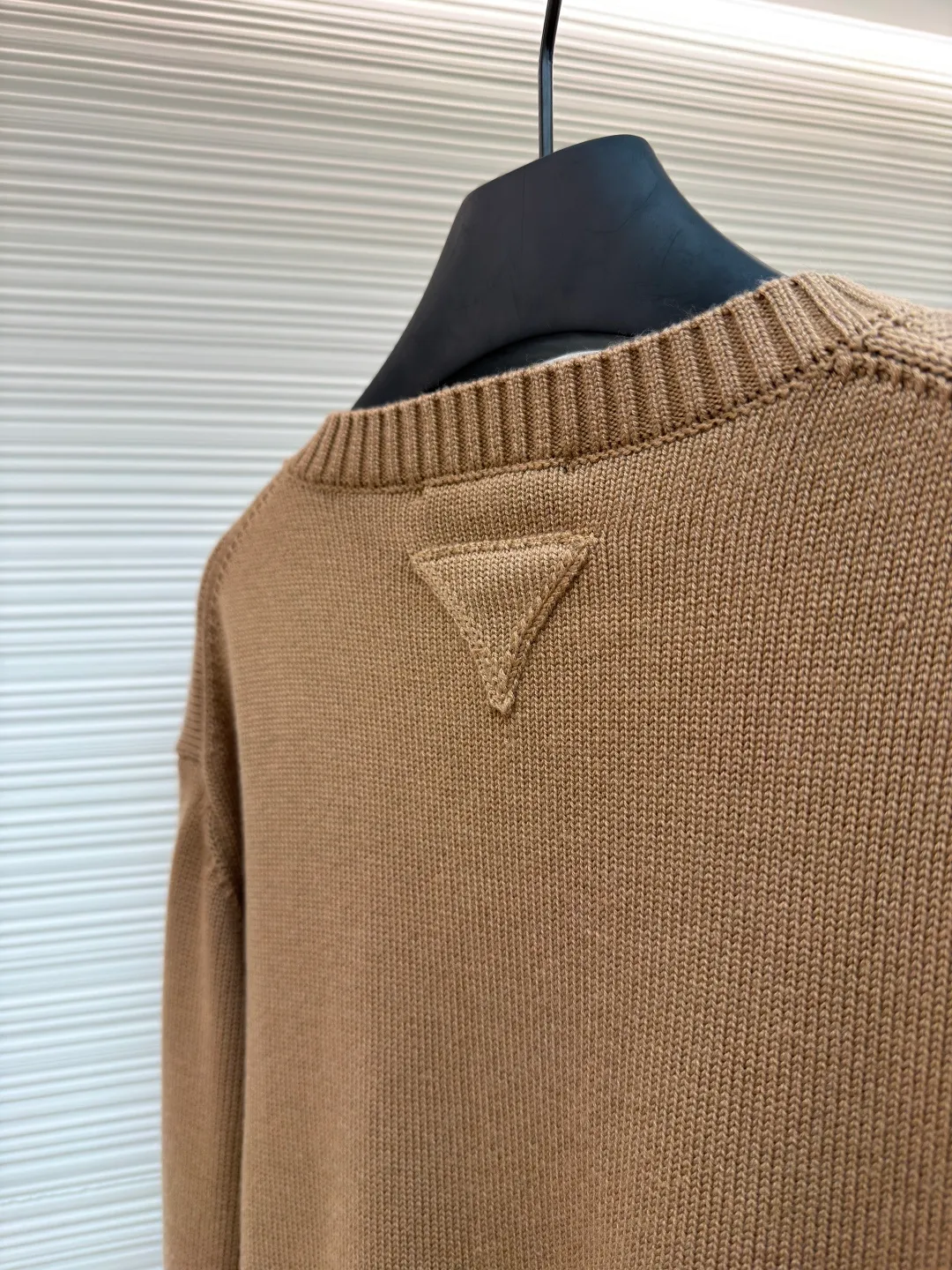 Prada round neck single-breasted cashmere cardigan ●Original version: Purchased and developed by 10189 ●Item number: 1681575-A85 ●Fabric: wool blended fabric ●Technology: knitted ●Color: camel ●Version: Fitted version ●Weight: about 830 grams ●Size: S-M-L-XL ●Description: This knitted cardigan is made of high-quality wool blended fabric, with a soft and delicate feel and excellent warmth retention properties. The body features a classic round neck design for a comfortable fit. The front placket is closed with a single-breasted button, making it easy to put on and take off and look neat. There are symmetrical pockets on both sides, which are practical and enhance the overall look. The knitted texture is clear and even, demonstrating exquisite craftsmanship. Ready-made garments undergo strict quality inspection to ensure that each piece meets high standards. Whether worn with a shirt or a T-shirt, this cardigan can show its unique fashion taste and texture. The overall wiring is straight and delicate, the fabric is comfortable and soft, and the color is consistent without color difference. It can be matched with the same style to create a fashionable look and control various occasions. Customized accessories, complete with three standards, same style for men and women!