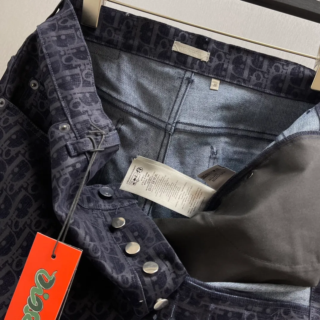 🅿️560 🧧CD blue cotton blend KAWS classic jeans SIZE: S-XL This classic jeans is from the DIOR AND KAWS limited series, showing the Ob1iique print. Crafted from blue cotton-blend denim, it features D1OR AND KAWS embroidery on the back, reinterpreting the Dior logo as a colorful snake. Pair it with the flocked Oblique print for a bold addition to casual looks.