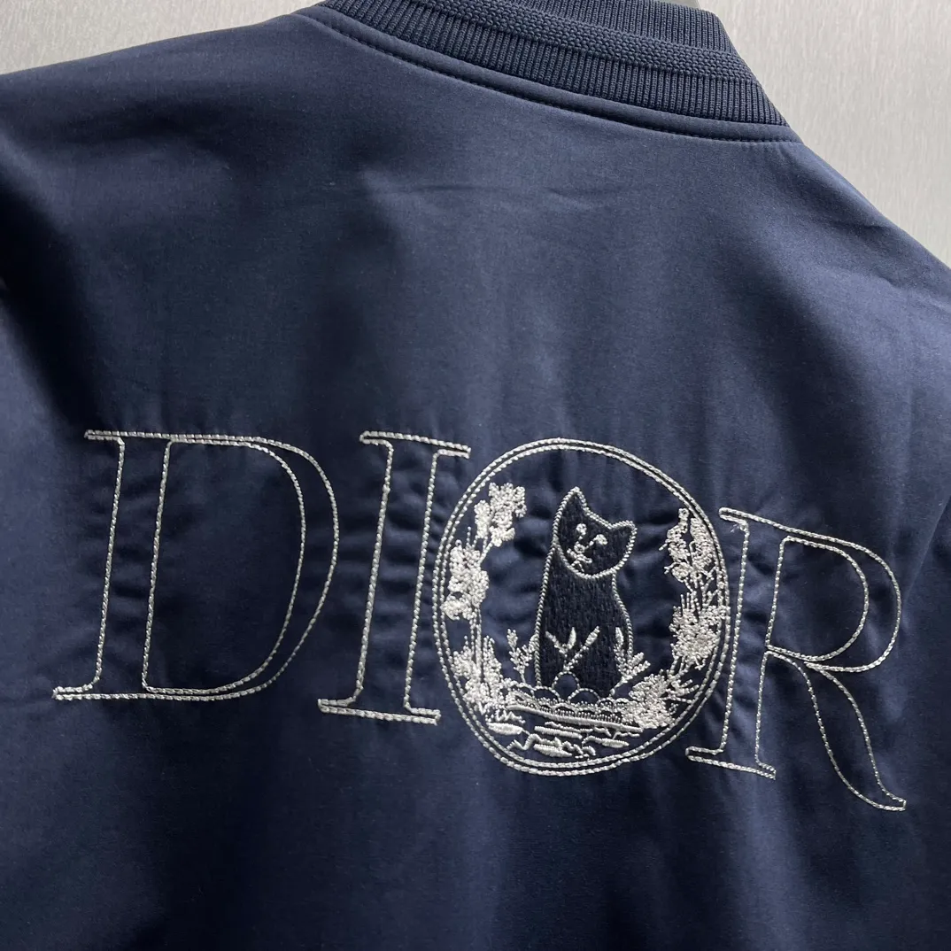 🅿️700 🧧CD Star Embroidered Bomber Jacket SIZE: S-XL This bomber jacket displays the Dior For My Real Friends logo from the DIOR AND HYLTON NEL collaboration. Crafted from navy cotton-blend in a comfortable fit with ribbed trim and welt pockets, it's embroidered with the collection's signature on the front and back. Wear it with a variety of everyday outfits.