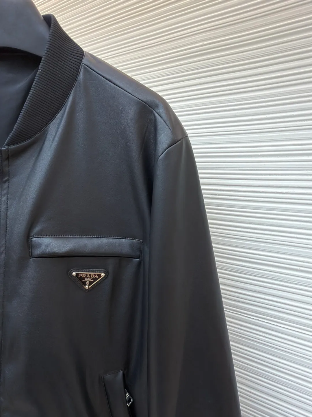 Prada reversible leather plain jacket ●Item number: 1681168-C65 ●Fabric: Leather lambskin fabric ●Technology: Ergonomic three-dimensional cutting ●Color: black ●Version: Fitted version ●Weight: about 970 grams ●Size: 46-48-50-52 ●Description: Customized Leather lambskin and rhyme-hole silky plain fabric, natural texture, natural luster, comfortable and close to the skin Double-sided charm, one garment for multiple enjoyments. On one side, the distinctive leather shows the noble texture, while on the other side, the simple plain grain interprets the low-key connotation. Clean lines and simple textures exude a sense of luxury from the inside out. The iconic enameled triangular metal logos are respectively embellished to highlight the elegance and nobility of the brand. It is highly recognizable. The two-sided transformation is wonderful and reflects each other. It unlocks a new dimension of fashion and uses imported infrared machines to locate the "Prada triangle logo" for more accurate positioning. Firm stone, ergonomic three-dimensional cutting, return to traditional craftsmanship through segmentation, folding, shrinking, and stretching techniques. The so-called slow work produces fine work, which is the respect for the material and the pursuit of feel. The workmanship is complex and tedious. Slow timeliness and high loss. The template machine opens the bag. The preset template guides the position, shape and size of the bag. The accuracy ensures the quality of the bag opening effect. The overall wiring is straight and delicate, the fabric is comfortable and soft, and the color is consistent without color difference. It can be matched with the same style to create a fashionable look and control various occasions. Customized accessories, complete with three standards, same style for men and women!