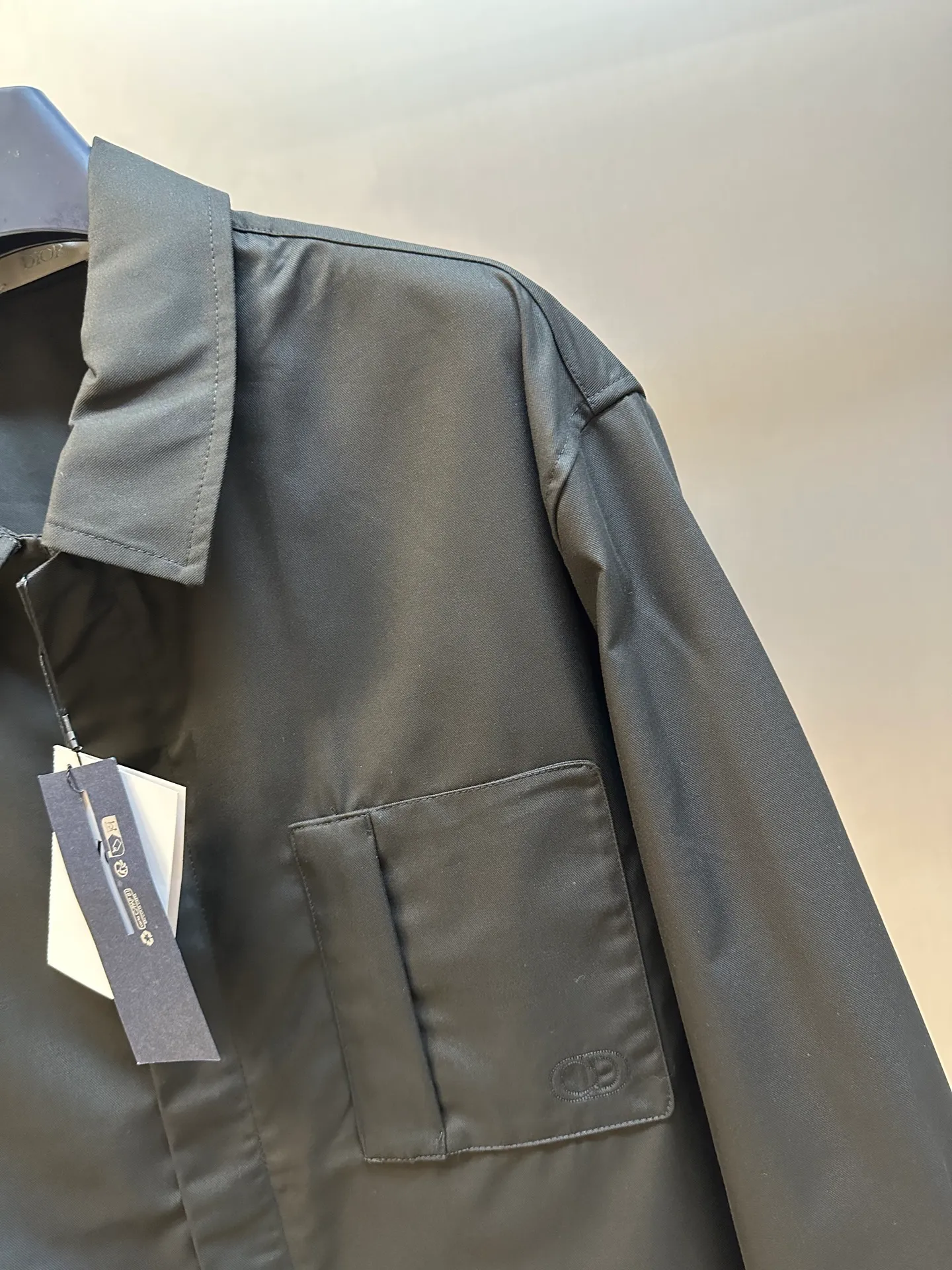 🅿️650 DIOR CD icon embroidered jacket is made of black gabardine fabric, with a smooth and delicate surface, soft touch, and elegant luster. Its tight textile construction makes it resistant to wrinkles, abrasion and drape. The wool component makes it warm and breathable. Gabardine fabric is not easy to pill, has good stain resistance, and is easy to care for daily.  The modern fit has a slim fit and a hidden zip closure adds understated sophistication. High-precision sewing technology ensures a perfect fit between the zipper and the fabric. The lapel design of traditional shirts still meets the needs of formal occasions. There is a patch pocket on the chest and is decorated with CD icon embroidery, which highlights the brand's iconic elements. The bag opening also has a hidden zipper opening, and the bag opening is reinforced with pocket knotting technology at the beginning and end. Tight stitching at the edge of the bag body makes it strong and beautiful. There are side pockets on the left and right sides, and the pocket openings are only 0.5 cm hemmed, which retains the smoothness of the overall lines without losing practicality. The double-button design of traditional shirt cuffs makes the cuffs fit more closely on the wrist and prevent them from loosening.  size：s m l xl