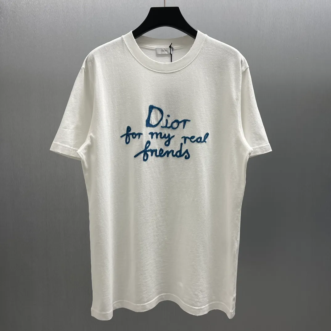 🅿️260 🧧CD True Friends Private Lettered Short Sleeves Size: S-XL This T-shirt displays the Dior For My Real Friends logo from the DIOR AND HYLTON NEL joint series. Crafted from white cotton jersey, it features a classic silhouette with a ribbed crew neck, embroidery on the chest for added style, and a burned-out effect on the collar, sleeves and hem. Cut for a relaxed fit, wear it with track pants or jeans.