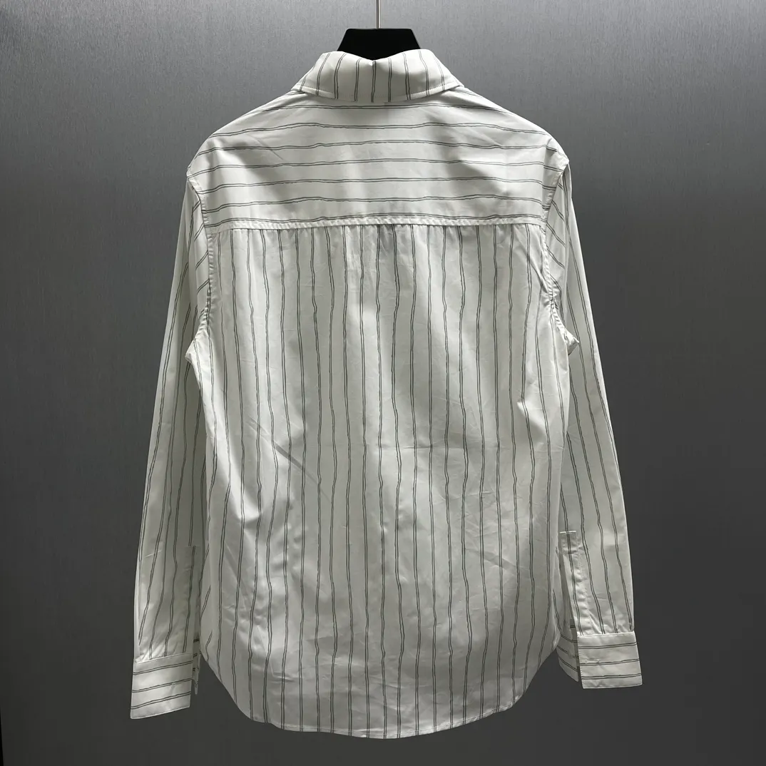🅿️480 CD Blue and gray vertical pattern simple embroidered shirt Size: S-XL This shirt combines modern style with traditional beauty. Crafted from white cotton poplin, it features a blue and gray striped pattern displaying the Dior For My Real Friends signature from the DIOR AND HYLTON NE collection. A patch pocket on the chest and hidden button closure complete the design. Can be worn with everyday clothing.