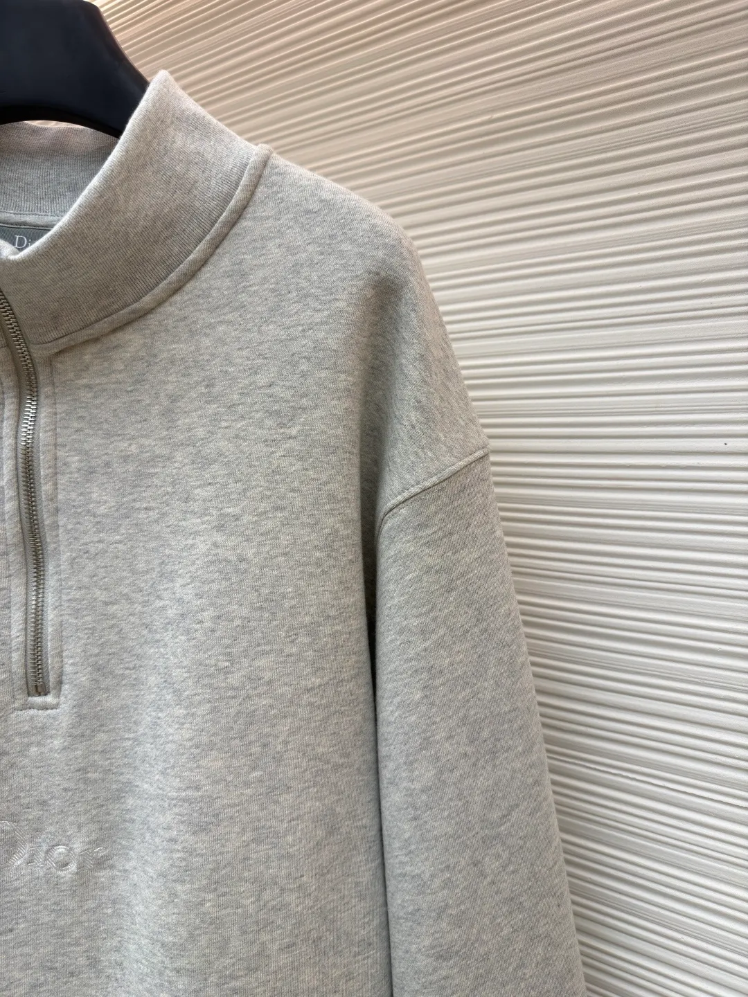 Dior half-zip logo sweatshirt ●Original version: 14,000 purchased and developed ●Item number: 1682496-A95 ●Material: pure cotton plush fabric ●Technology: twill logo embroidery production ●Color: gray ●Version: fitted version ●Weight: about 630 grams ●Size: XS-S-M-L ●Description: The fabric is a heavyweight high-end sweatshirt fabric. The 26-count double yarn forms the smooth and delicate outer surface of the fabric, while the 10-count plush yarn base is precision brushed to form a layer of rich, dense skin-friendly fluff, providing excellent softness and warmth. Its extremely high weight and elasticity brought by spandex ensure the ultimate thickness, stiffness and strong elastic recovery of the collar, cuffs and hem, which is the key to creating a neat silhouette and ensuring durability. Made of twill flat stitch embroidery. This is an embroidery technique that uses parallel stitches at specific angles to fill in, creating a flat, smooth and full embroidery surface with fine diagonal texture. The brand logo is presented in a delicate, strong and textured way, and the precision of the embroidery creates a high-end contrast with the casual feel of the sweatshirt fabric. The overall wiring is straight and delicate, the fabric is comfortable and soft, and the color is consistent without color difference. It can be matched with the same style to create a fashionable look and control various occasions. Customized accessories, complete with three standards, same style for men and women!