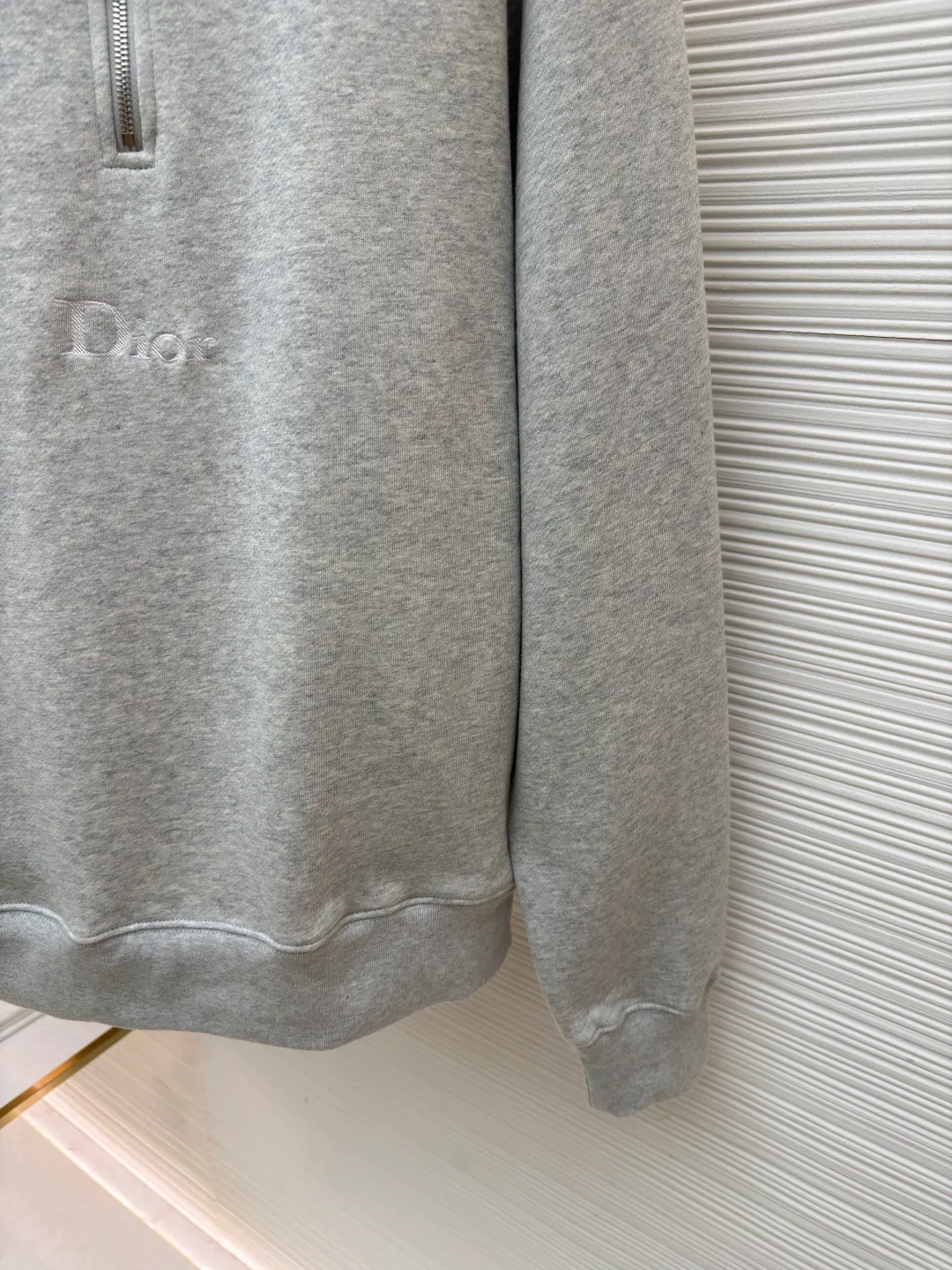 Dior half-zip logo sweatshirt ●Original version: 14,000 purchased and developed ●Item number: 1682496-A95 ●Material: pure cotton plush fabric ●Technology: twill logo embroidery production ●Color: gray ●Version: fitted version ●Weight: about 630 grams ●Size: XS-S-M-L ●Description: The fabric is a heavyweight high-end sweatshirt fabric. The 26-count double yarn forms the smooth and delicate outer surface of the fabric, while the 10-count plush yarn base is precision brushed to form a layer of rich, dense skin-friendly fluff, providing excellent softness and warmth. Its extremely high weight and elasticity brought by spandex ensure the ultimate thickness, stiffness and strong elastic recovery of the collar, cuffs and hem, which is the key to creating a neat silhouette and ensuring durability. Made of twill flat stitch embroidery. This is an embroidery technique that uses parallel stitches at specific angles to fill in, creating a flat, smooth and full embroidery surface with fine diagonal texture. The brand logo is presented in a delicate, strong and textured way, and the precision of the embroidery creates a high-end contrast with the casual feel of the sweatshirt fabric. The overall wiring is straight and delicate, the fabric is comfortable and soft, and the color is consistent without color difference. It can be matched with the same style to create a fashionable look and control various occasions. Customized accessories, complete with three standards, same style for men and women!