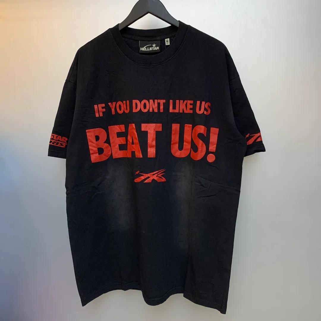 P134 Hellstar Beat Us! T-Shirt Custom Cut and sew garment manufactured in Los Angeles. Dyed and potassium sprayed with jumbo screen print. Fits slightly oversized. Gentle wash tumble dry. Dry clean preferred Newly popular Hellstar short-sleeved T-shirt!   Standard beauty and trendy workmanship, original customization (fabric, pattern, printing, hang tag, main mark, etc.), exaggerated style, explosive style, dare to break through tradition, bring adventurous new fashion experience!  YoungBoy, the most popular rapper in the youth circle, has shot a lot of models for him, and celebrities such as Dababy and Swae Lee frequently get dressed!  color: Vintage Black (washed black)