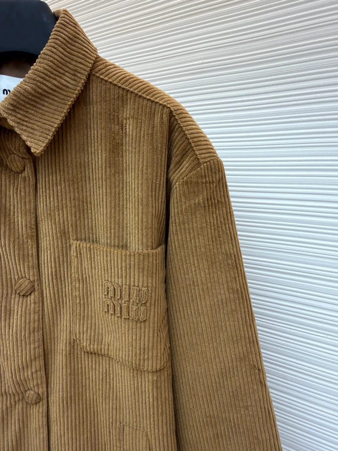 MIU MIU corduroy texture down cotton jacket ●Original version: 25400 purchased and developed ●Item number: 1681328-B50 ●Fabric: corduroy fabric ●Technology: embroidery production ●Color: brown ●Version: fitted version ●Weight: about 720 grams ●Size: 38-40-42 ●Description: Made of high-quality corduroy fabric, the velvet strips are full and regularly arranged. Through a special weaving process, the fabric has a soft touch and good warmth retention, while showing a retro and high-end texture. The "MiuMiu" brand logo on the chest pocket uses three-dimensional embroidery technology. The embroidery stitches are fine and even, the pattern outline is clear, and it is perfectly integrated with the corduroy fabric, which not only highlights the brand identity, but also improves the overall craftsmanship sophistication. It adopts a loose silhouette and is in line with the current fashion trend. It is comfortable and tolerant to wear. The flat stitching process is used during sewing, the stitching is straight, the stitch length is even, and the splicing of the garment pieces is smooth and snug, reflecting the exquisite level of garment making. The overall wiring is straight and delicate, the fabric is comfortable and soft, and the color is consistent without color difference. It can be matched with the same style to create a fashionable look and control various occasions. Customized accessories, complete with three standards, same style for men and women!