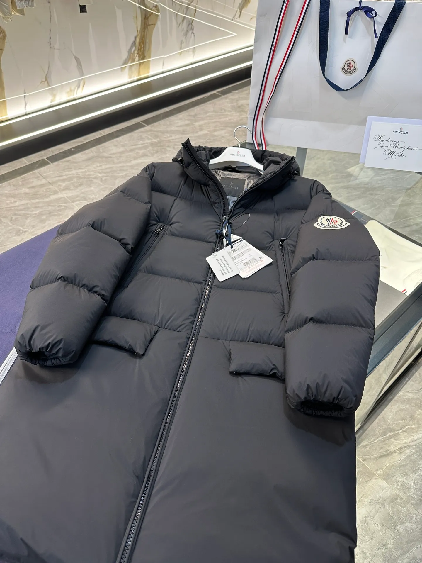 P1120 Moncler Bosona mid-length large felt badge down jacket. More details shot.