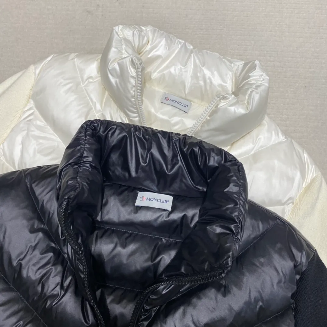 P720 Moncler Women's Stand Collar Knitted Patchwork Down Jacket This padded cardigan is a classic Moncler design piece that can be worn alone or paired with coats and jackets. Lightweight knit style made from soft wool and filled with down on the front and back. Color: black/white Size: 1/2/3/4
