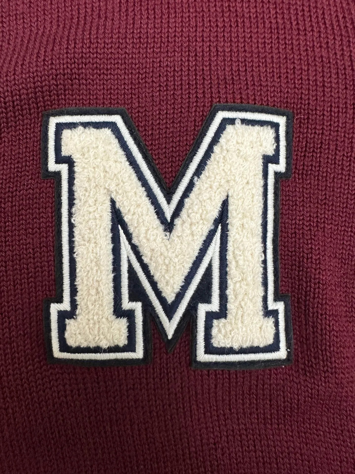P640 💰 Moncler Men's embroidered monogram wool cardigan M embroidered college-style cardigan is inspired by college-style baseball uniforms. The main color is Bordeaux red with off-white striped ribbing on the cuffs and hem. There is a three-dimensional "M" letter embroidery on the left chest. The overall style is a retro campus feel.  The detailed logo buttons are engraved with the Moncler brand, and the embroidered letters are terry embroidered. The material is 100% wool jersey (7-needle process). It is a medium-thick item. It has button closure + V-neck + patch pocket design. It has a balance of warmth and practicality. It belongs to the Moncler men's casual knitting series. The style is suitable for layering shirts and T-shirts.  Size: S, M, L, XL,