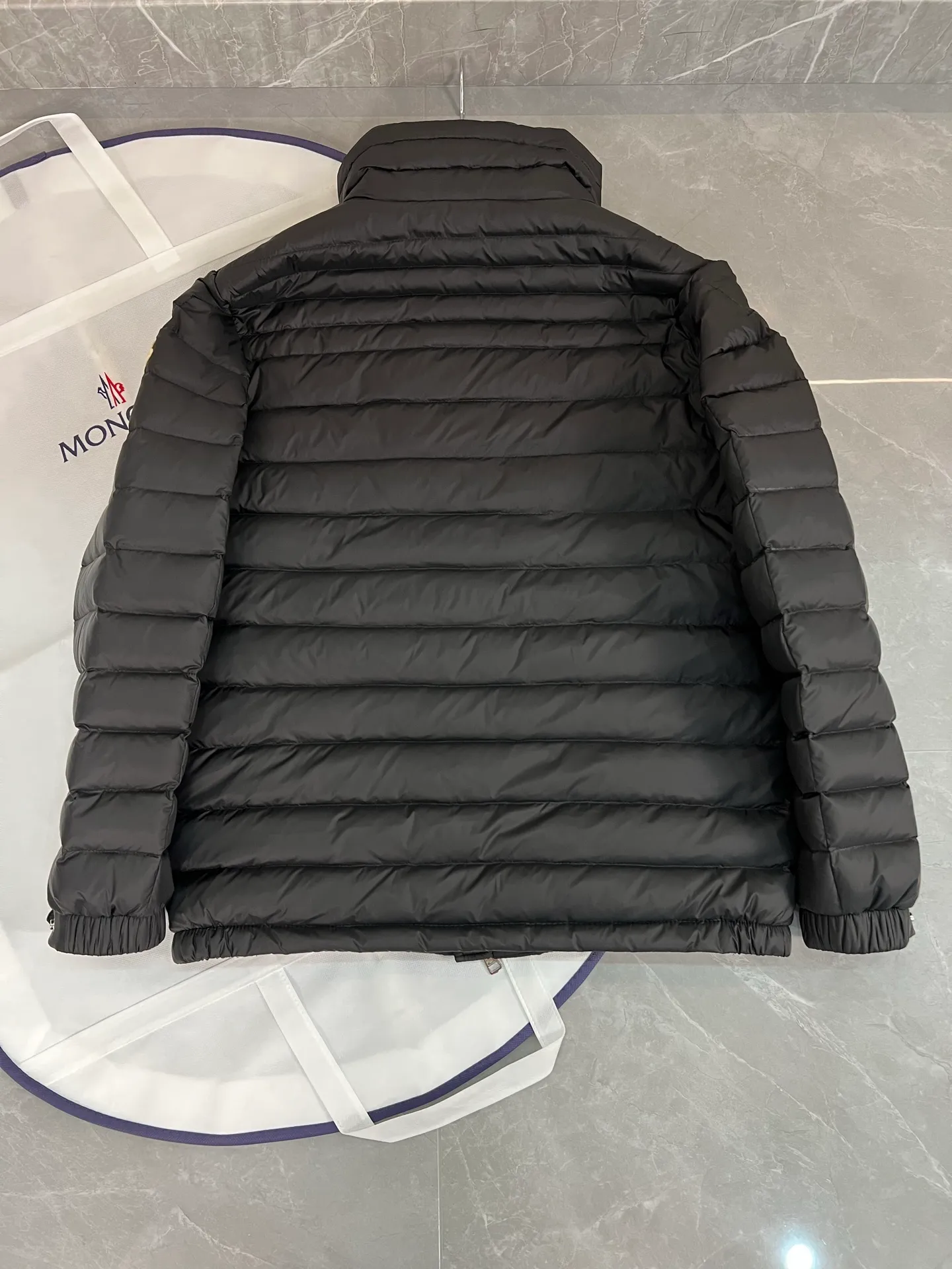 The P780 Arnique hooded down jacket with polyester outer fabric is Moncler's classic men's design.