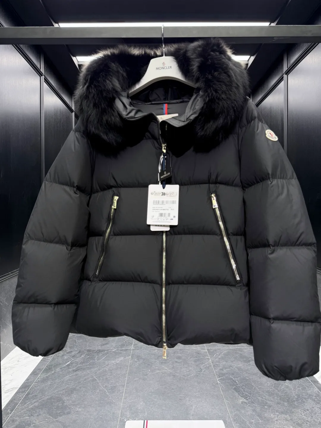 P1040 Premium down ⬆️Moncler Laichefur hooded short down jacket. Duck down filling. Oversized fur collar. Original replacement fabrics ➕Original matching hardware. The tag bar code is complete and consistent with the official website. The tag has built-in NFC electronic sensor anti-counterfeiting. Supports multiple anti-counterfeiting verifications. The Laichefur women's short down jacket is classic and elegant, with a detachable wool collar.  Product Details: The Laichefur Down Jacket is designed to be both feminine and practical for all-day wear. Features a hood in brushed polyester with an elegant matte finish. Paired with a detachable fleece collar, it provides warmth and protection in different environments.  Details: •Made from brushed polyester •Longue saison lining •Down filling •Hood •Removable fleece collar •Zip closure •Zip pockets Size: 1-4 Black/Off White
