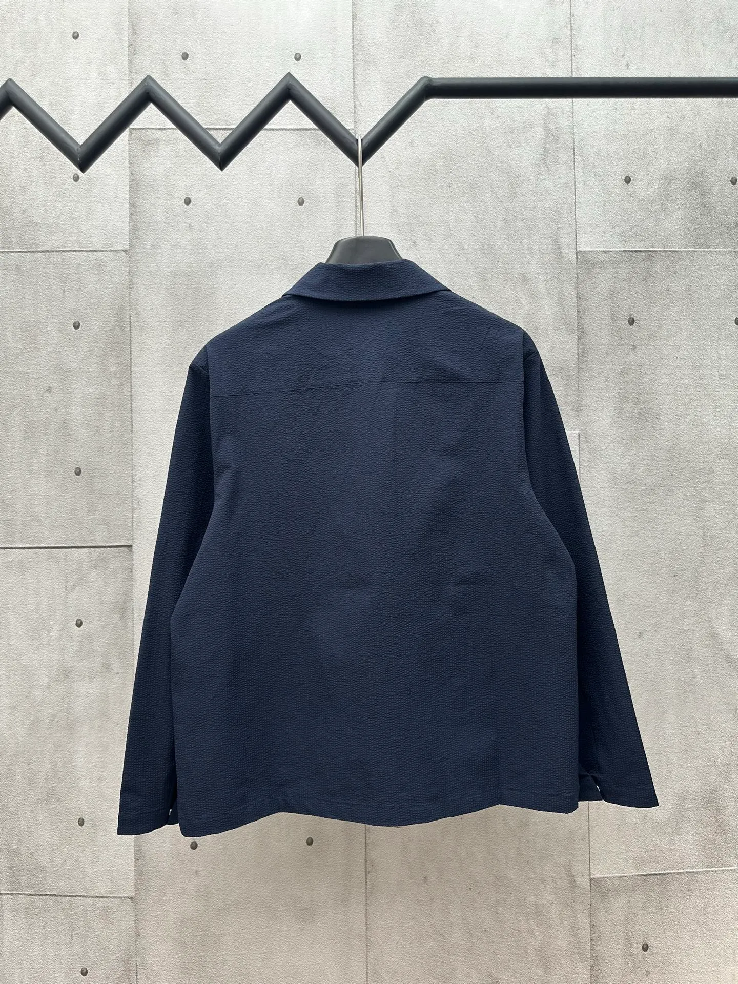 P440 MONCLER bubble wrinkle shirt jacket Fabric selection: Made of cotton blended woven fabric with 76% high cotton content + 24% polyester fiber. The high cotton content ensures that the fabric is soft, skin-friendly, and has good breathability. The addition of a small amount of polyester fiber balances the wrinkle resistance and elasticity of the overall fabric and greatly reduces its shrinkage. After preshrinking, dimensional changes during washing are negligible. The fusion of the two makes the fabric combine anti-wrinkle, quick-drying, easy care and other characteristics without losing the advantages of good wearing experience and strong breathability.  Bubble wrinkle technology: ground warp + bubble warp independent let-off. The bubble warp yarn feeding speed is about 20% higher than the ground warp yarn feeding speed. During weaving, the bubble warp is relaxed and accumulated, forming a naturally arched bubble unit. Through the alternating arrangement of yarns + floating length tissue changes, a clear grid frame is built between the bubble units, and finally the bubble three-dimensional effect and grid outline are locked through high-temperature heat setting.  Accessories: One-to-one customized zipper puller, one-to-one customized LOGO armband, one-to-one customized snap button SIZE: 1 2 3 4