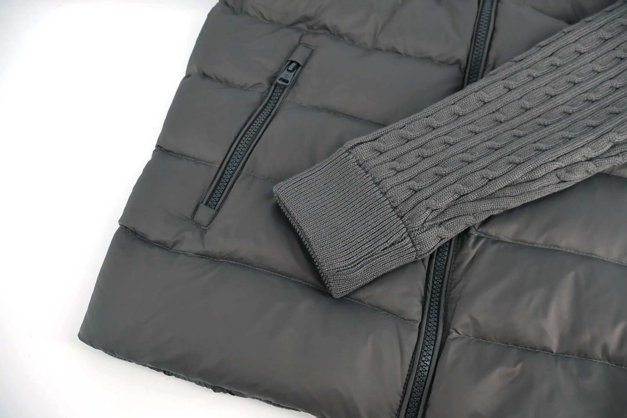 P970 Moncler muffled woolen patchwork down jacket (grey). The outer front fabric is made of 100% nylon (nylon). Its high-density structure achieves excellent windproof effect. It also has strong wear resistance and wrinkle resistance. It is scratch-free for daily wear and can be easily taken care of. The splicing design of sweaters and down jackets not only retains the thermal performance of down jackets, but also incorporates the fashion elements of sweaters, making the overall garment both practical and fashionable. High-quality material: filled with high-quality white duck down, with a filling capacity of 100g, which has excellent thermal insulation effect. At the same time, the sweater is made of wool, cashmere and other natural fibers, which are soft, comfortable and skin-friendly. The sweaters and down jackets are carefully spliced ​​to ensure comfortable wearing and are not prone to threading or velvet loss. High collar design: not only provides excellent thermal insulation effect, but also adds a unique sense of fashion, allowing the wearer to maintain style in the cold season. Stripe decoration: The stripes on the sleeve arms are like bright brush strokes, embellished on the dark gray down jacket, injecting vitality and movement into the overall look, making the clothing more eye-catching. Size:1-2-3-4-5