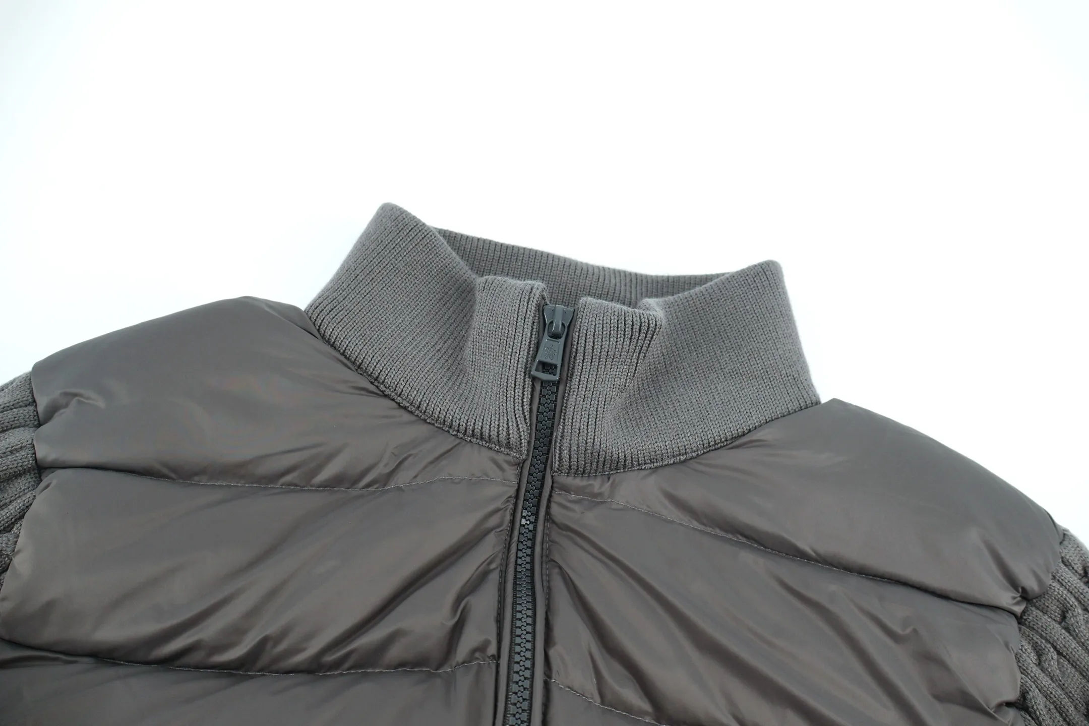 P970 Moncler muffled woolen patchwork down jacket (grey). The outer front fabric is made of 100% nylon (nylon). Its high-density structure achieves excellent windproof effect. It also has strong wear resistance and wrinkle resistance. It is scratch-free for daily wear and can be easily taken care of. The splicing design of sweaters and down jackets not only retains the thermal performance of down jackets, but also incorporates the fashion elements of sweaters, making the overall garment both practical and fashionable. High-quality material: filled with high-quality white duck down, with a filling capacity of 100g, which has excellent thermal insulation effect. At the same time, the sweater is made of wool, cashmere and other natural fibers, which are soft, comfortable and skin-friendly. The sweaters and down jackets are carefully spliced ​​to ensure comfortable wearing and are not prone to threading or velvet loss. High collar design: not only provides excellent thermal insulation effect, but also adds a unique sense of fashion, allowing the wearer to maintain style in the cold season. Stripe decoration: The stripes on the sleeve arms are like bright brush strokes, embellished on the dark gray down jacket, injecting vitality and movement into the overall look, making the clothing more eye-catching. Size:1-2-3-4-5