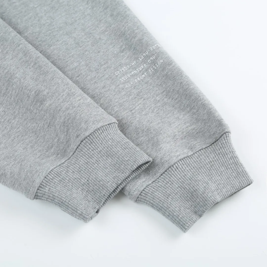P370 MONCLER printed round neck sweatshirt Fabric selection: Single-sided fish scale fabric woven with cotton as the base. The front is a smooth knitted surface, and the skin-touching surface is formed into three-dimensional terry through the floating thread knitting technology of the knitting machine, which increases the fluffiness and has a delicate touch. The terry structure absorbs a large amount of water and evaporates quickly, so it is not easy to loosen and deform after repeated washing.  Process 1: Use glue printing to present 4 high-saturation patterns on the fabric. The pressure of the scraper is even, and the scraping printing is done in 3 times to ensure that the glue is fully penetrated and covered. After curing at high temperature, the pigment is firmly bonded to the cotton fiber. The ink-absorbing and penetrating properties of the cotton fiber make the pattern less likely to fall off due to friction.  Process 2: The 2*2 rib formed by alternating longitudinal rows of front coils and longitudinal rows of back coils is still very elastic and has a wide pattern that fits the wrist and waist without a sense of restraint. The gaps between the coils allow air to circulate without losing warmth.  Process 2: By actively interfering with the shrinkage potential of cotton fibers, the fabric is able to transition from changeable to stable, improving dimensional stability while being less prone to deformation and wrinkles.  Accessories: One to one customized 3-standard SIZE: S M L XL