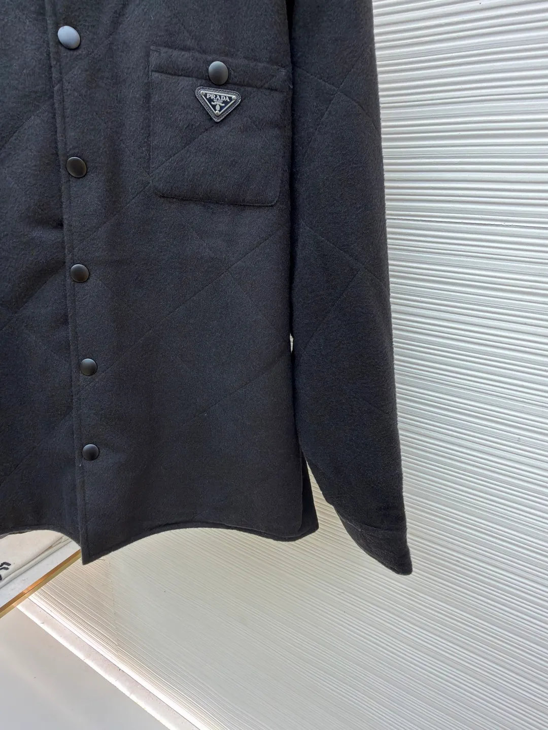 Prada Triangle Label Lapel Cotton Jacket ●Original version: Purchased and developed for 24900 ●Item number: 1682225-B60 ●Fabric: Wool blended fabric ●Technology: Manual disassembly and production ●Color: black ●Version: Fitted version ●Weight: about 800 grams ●Size: S-M-L-XL ●Description: Customized Xuanguang cashmere blend and large plaid down cotton with excellent texture Every inch contains a heavy sense of warmth. The main color is matte black with a touch of light. The rhombus matrix is used as the canvas to form a dynamic visual trap. The iconic enamel-coated triangular metal logo is embellished to highlight the elegance and nobility of the brand. The lining and down cotton design highlight the wrapping effect. It cleverly combines the warmth of cotton clothing with the aesthetics of life. It displays unparalleled luxury and charm in a low-key manner. The infrared positioning of the "Prada triangle mark" by an imported special machine is more precise and firm. Purely manual post-water disassembly process. After completing the initial combination of the lining cloth and the down cotton, the craftsmen will make further adjustments and disassembly in the water. The lining cloth and the down cotton can achieve a perfect combination, making the lining cloth and the down cotton more closely combined. Beautiful and neat, the template machine lines. The computer template machine's line process shows extremely high neatness and smoothness. The craftsman accurately controls the size during the operation to ensure that each line meets the design requirements. The lines of the entire template are smooth and unified. Neat and beautiful. The overall wiring is straight and delicate, the fabric is comfortable and soft, and the color is consistent without color difference. It can be matched with the same style to create a fashionable look and control various occasions. Customized accessories, complete with three standards, same style for men and women!