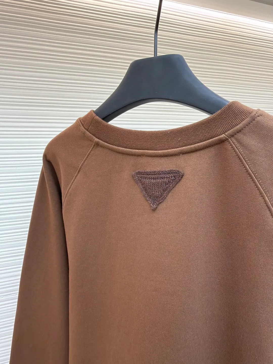 Prada wool triangle lapel knitted sweatshirt ●Original version: purchased and developed by 10420 ●Item number: 1681924-A55 ●Fabric: Loop cotton fabric ●Technology: knitted ●Color: brown ●Version: fitted version ●Weight: about 615 grams ●Size: XS-S-M-L ●Description: Made of 26S double yarn + 10S reverse terry base yarn, 380g; paired with 21S double yarn rib, 470g. The double-sided basic structure has better bottom-locking ability, and it uses spandex yarn to lock the fabric surface tightly. Even if it is made into a thick fleece effect, the lint loss is still less than that of ordinary sweatshirt fleece fabrics. The texture is clear and delicate, and the cloth surface is clean and smooth; after stretching, the cloth surface can quickly return to flatness, making it wide and easy to shape. The inverted triangle logo is woven from 5S pure cotton wool and processed through multi-layer structure, handcrafting and other processes. The material and process requirements are high, ensuring clean lines without burrs, moderate thickness and elasticity, enhancing three-dimensional effect and durable function. The logo uses a multi-layer composite process to achieve a three-dimensional embossed effect, and the back is reinforced to prevent deformation. The logo is then embroidered on the surface of the fabric using high-precision machinery. This process can achieve a delicate presentation of complex patterns and create a relief effect. The overall wiring is straight and delicate, the fabric is comfortable and soft, and the color is consistent without color difference. It can be matched with the same style to create a fashionable look and control various occasions. Customized accessories, complete with three standards, same style for men and women!